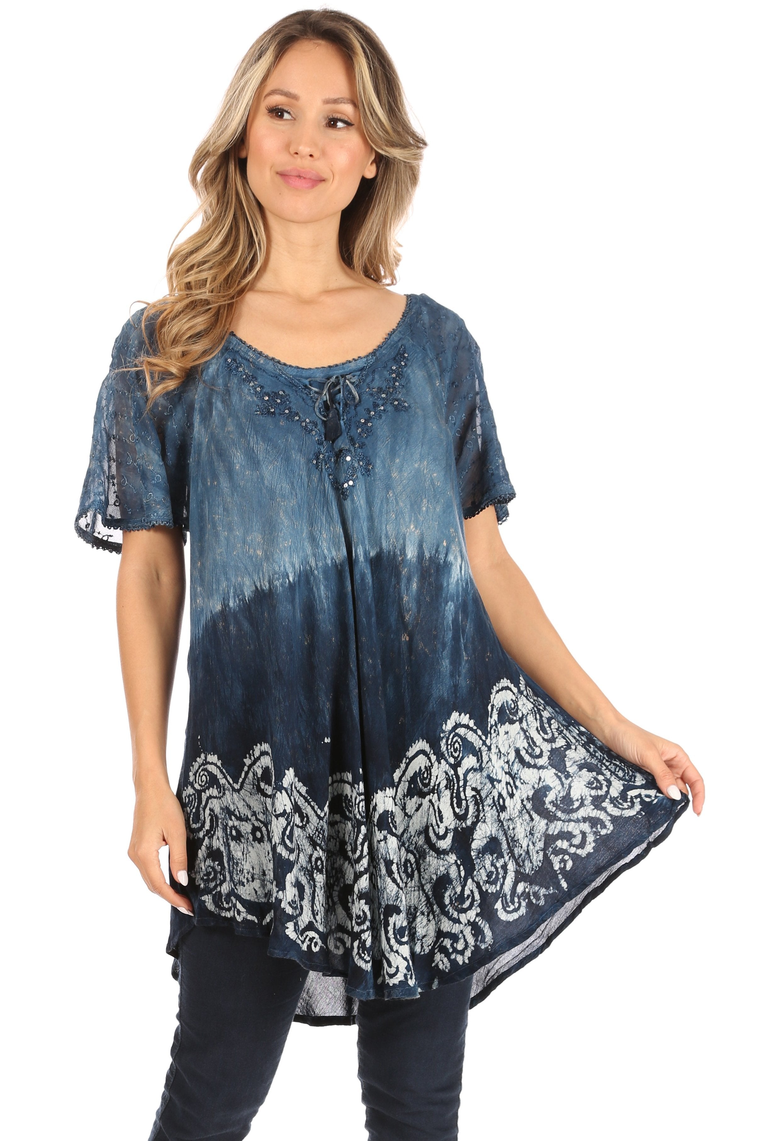 Woman wearing a blue tie-dye tunic with white patterns on a white background