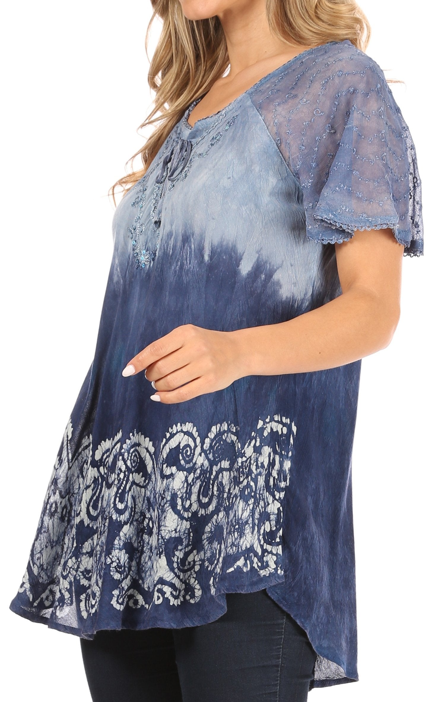 Woman wearing a blue tie-dye top with lace details on a white background