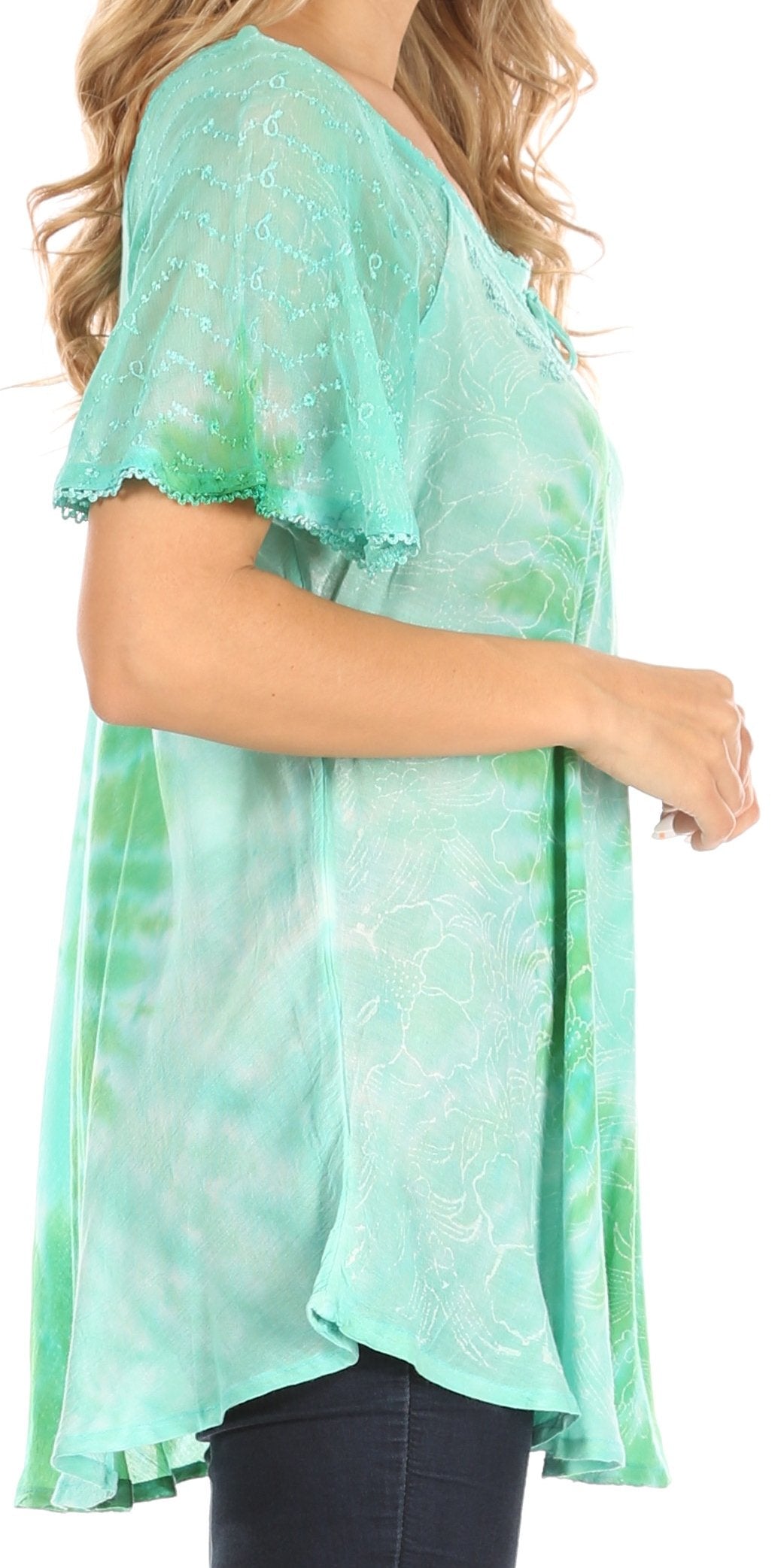 Green patterned blouse worn by a person on a white background