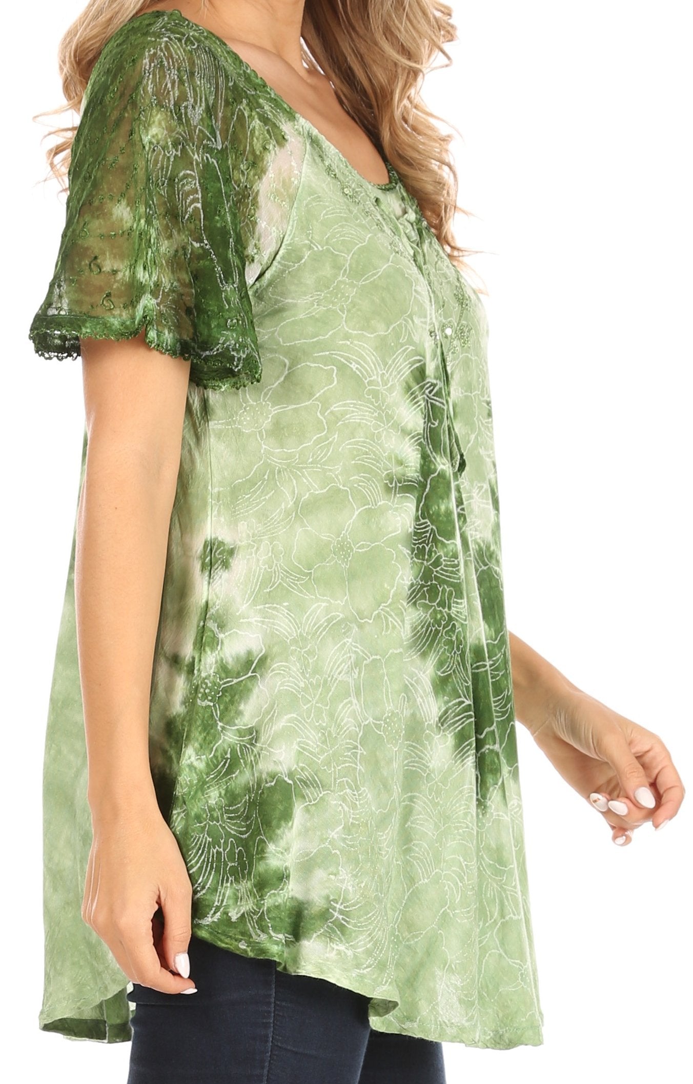 Green patterned blouse worn by a person on a white background