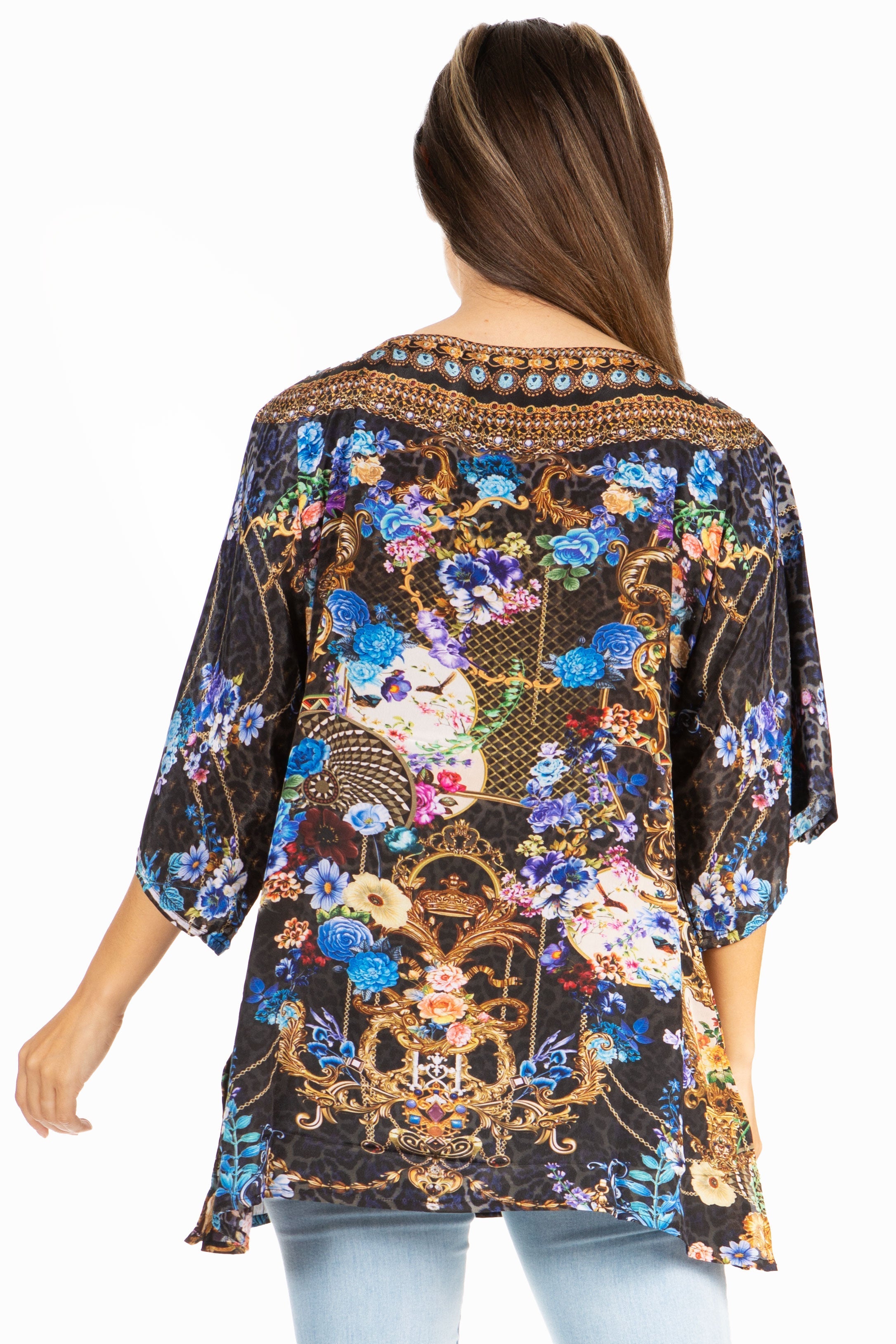 Woman wearing a colorful floral and geometric patterned top on a white background
