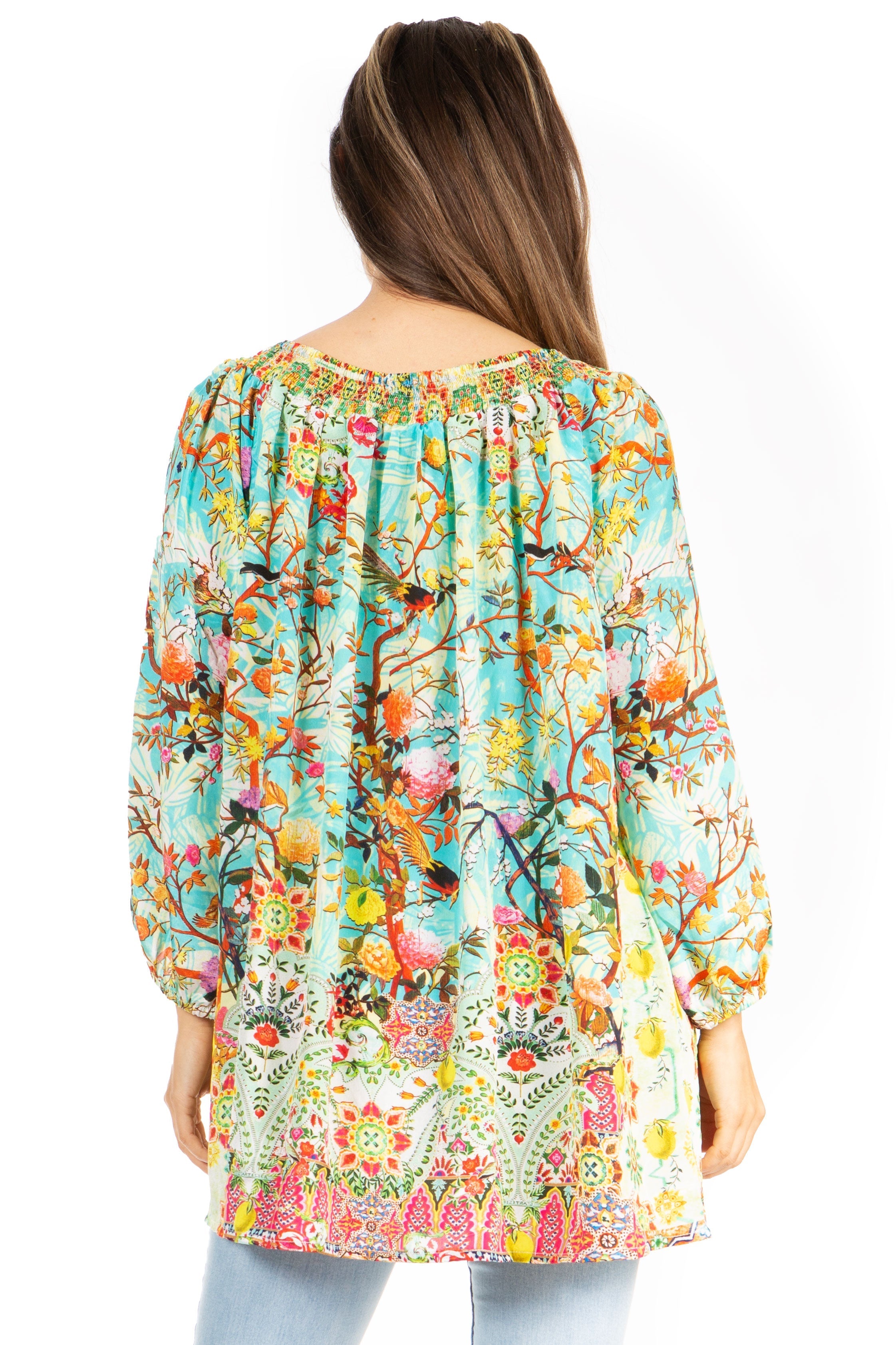 Woman wearing a colorful floral patterned blouse on a white background