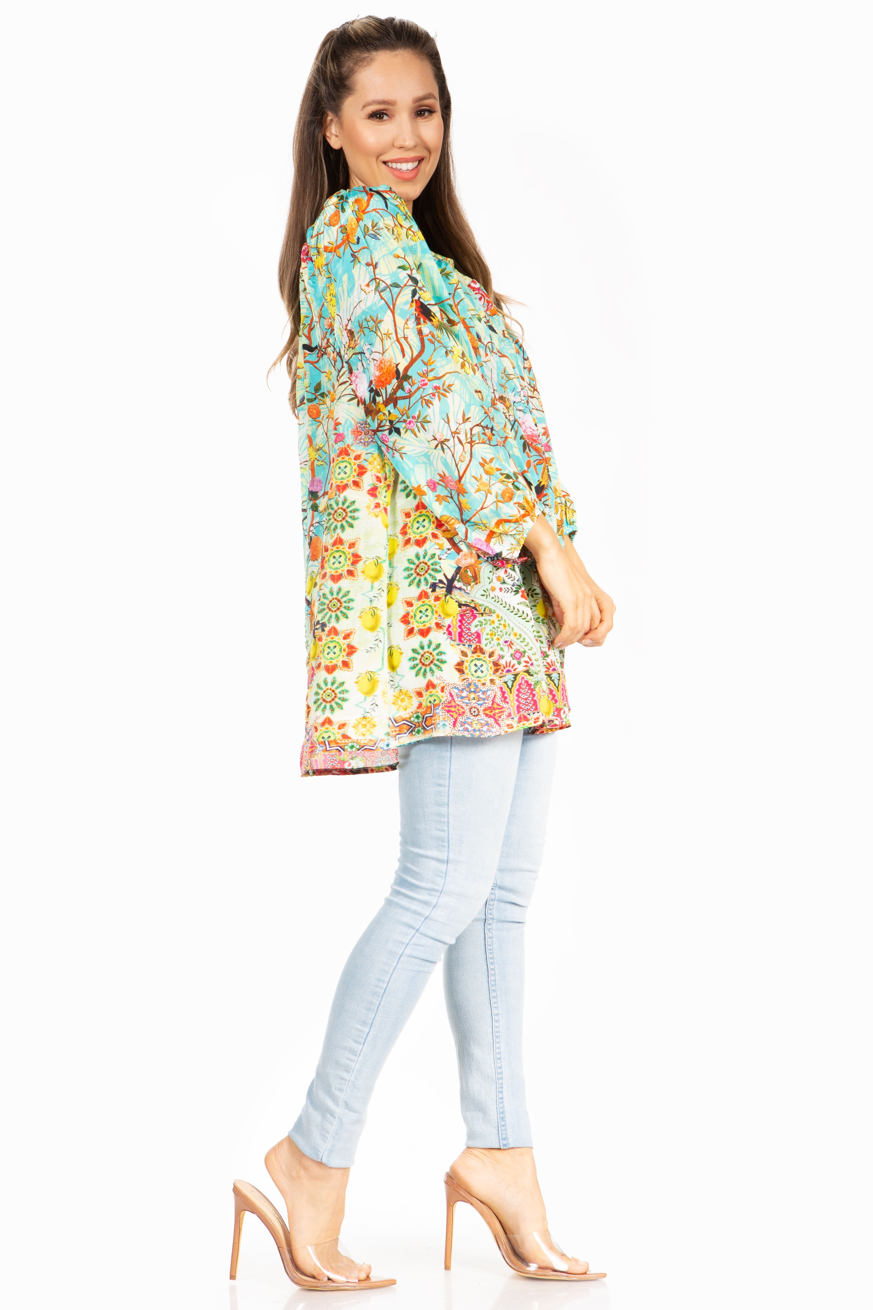 Woman wearing a colorful floral blouse and light blue jeans on a white background