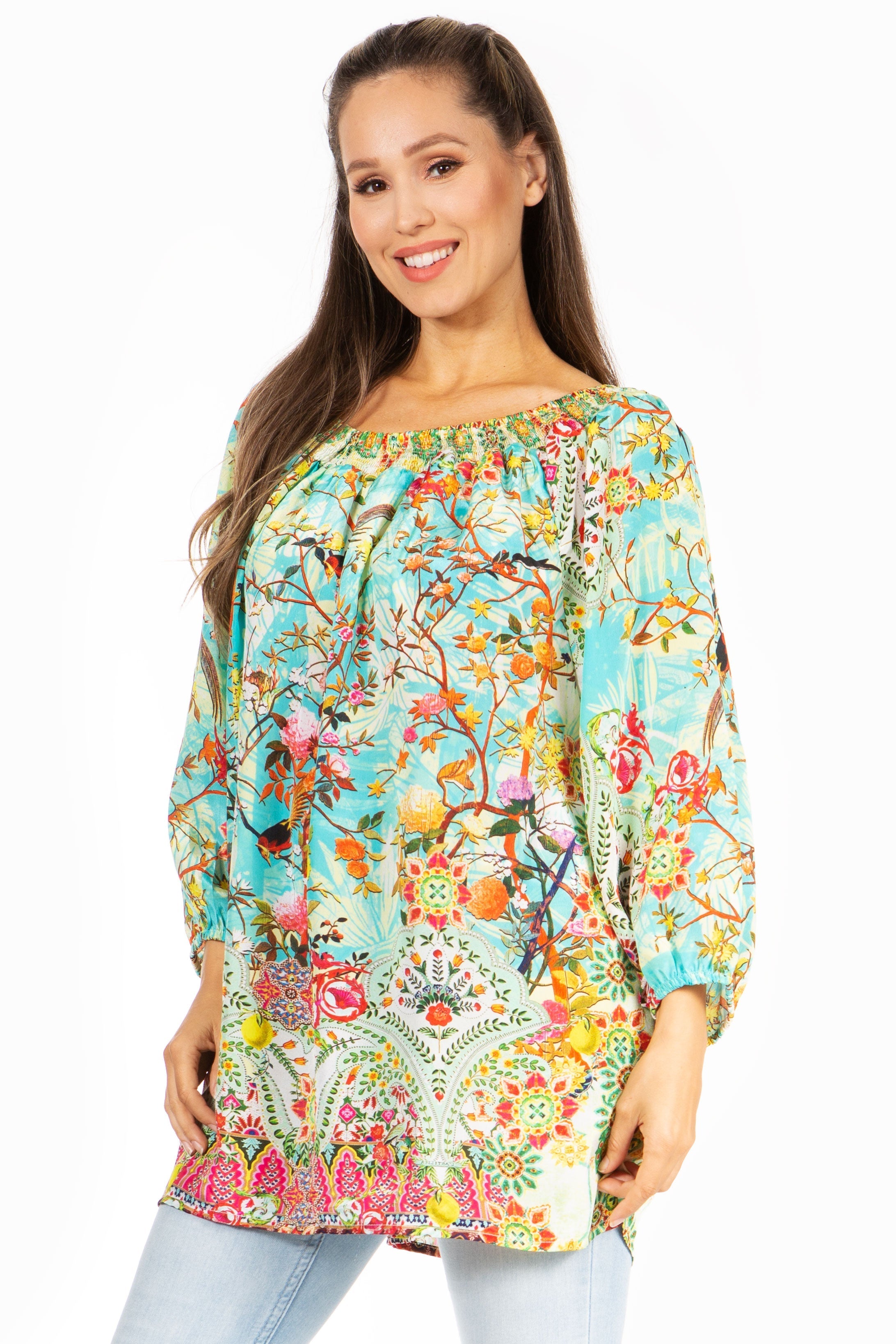Woman wearing a colorful floral patterned top on a white background
