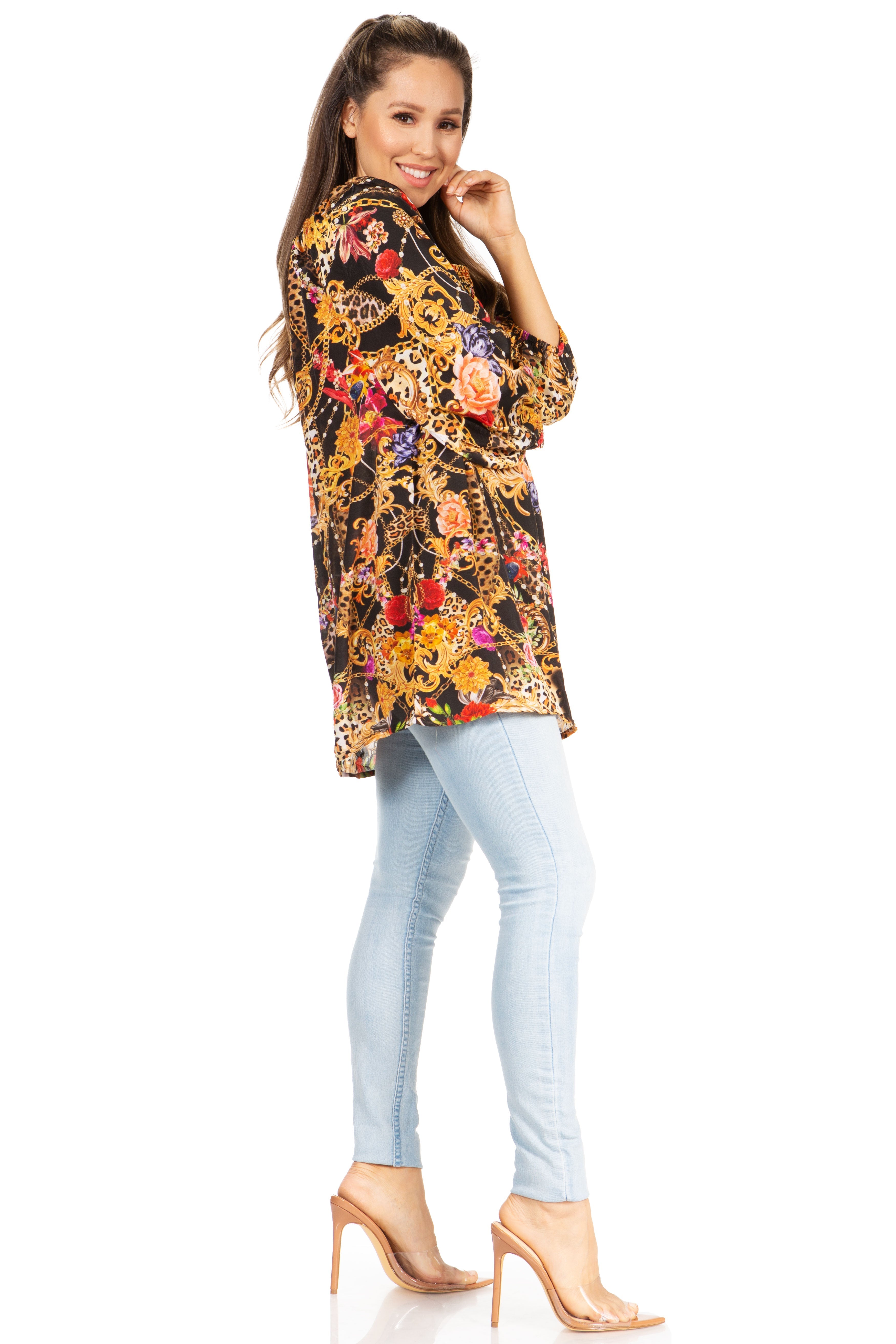 Woman wearing a floral blouse and light blue jeans on a white background