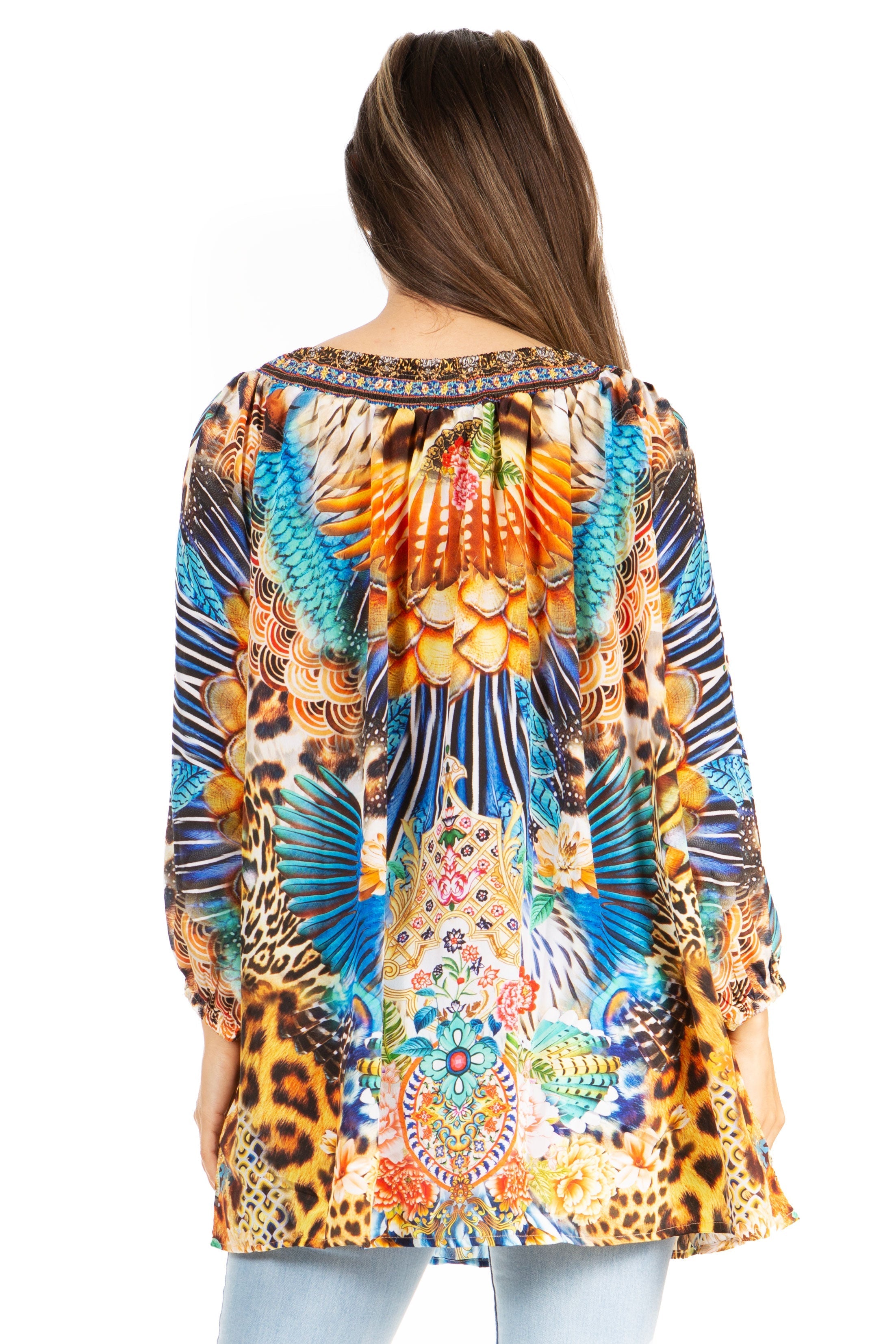 Woman wearing a colorful patterned top with long sleeves on a white background