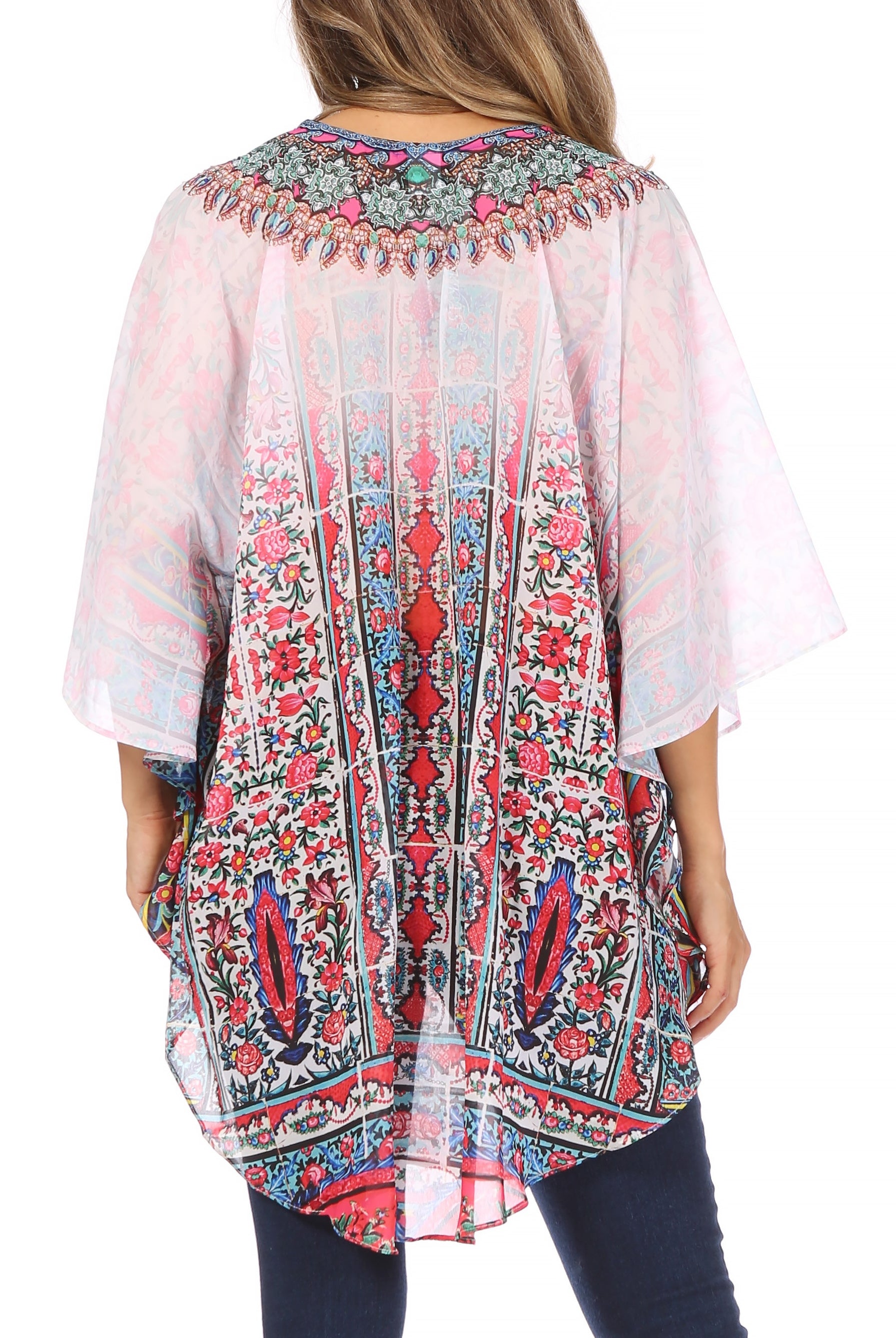 Woman wearing a colorful patterned kimono-style top on a white background