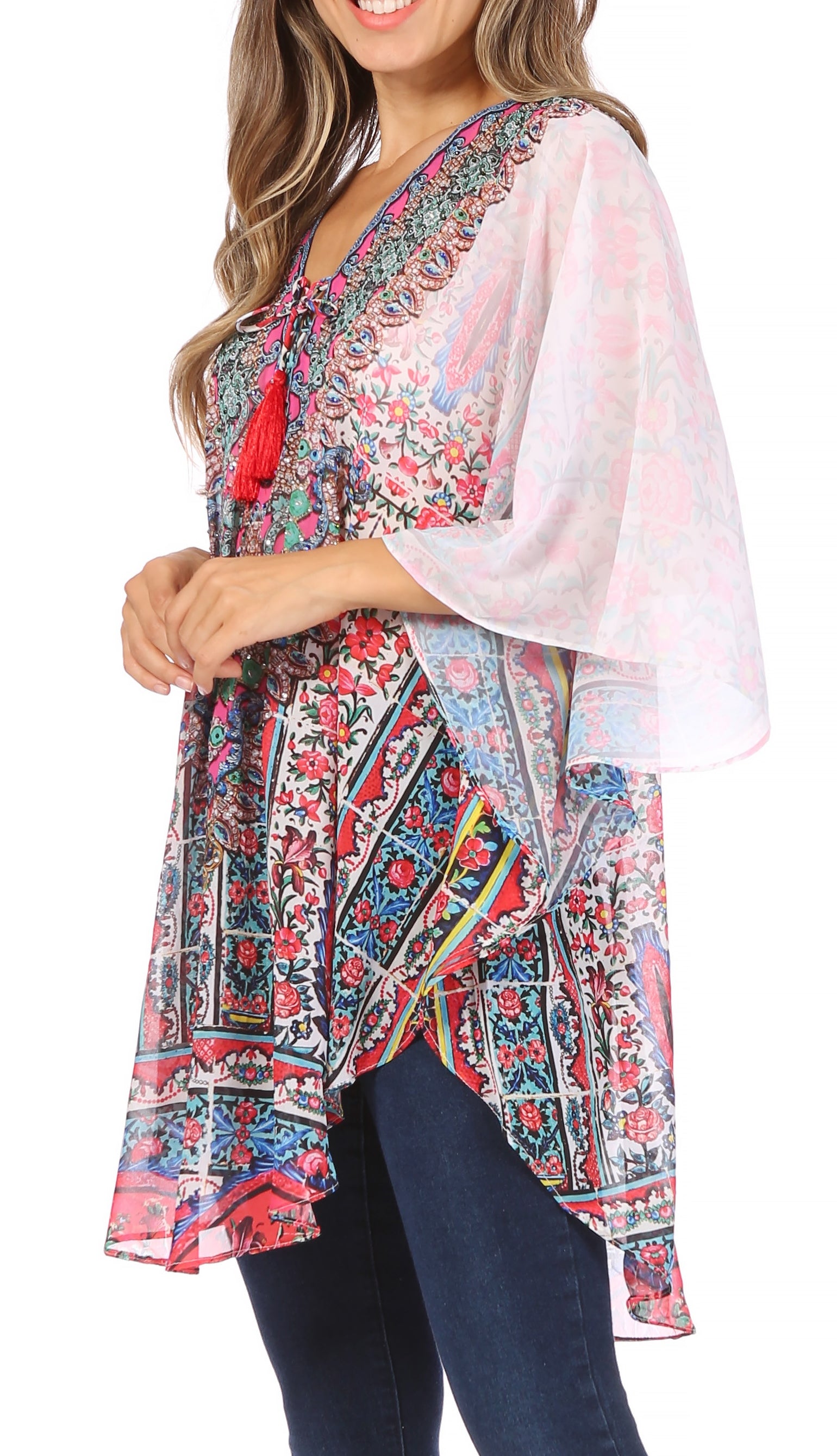 Woman wearing a colorful floral kimono-style top with a white background