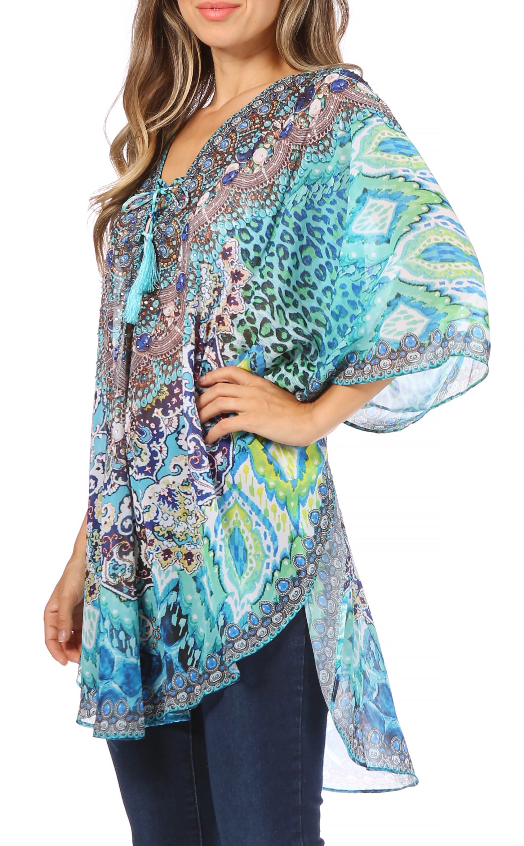 Woman wearing a colorful patterned blouse with bell sleeves on a white background