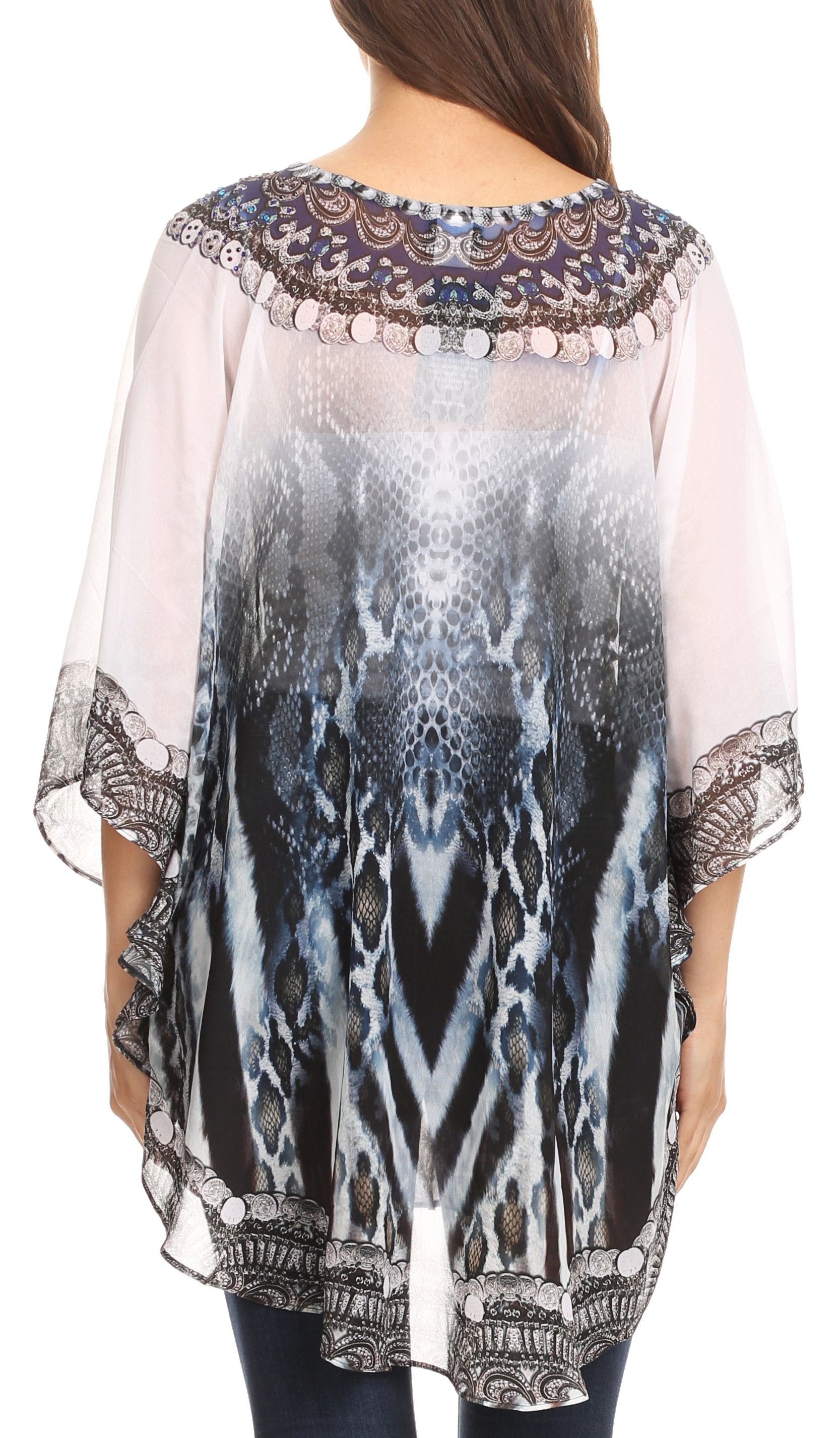 Woman wearing a sheer blouse with abstract pattern and embellishments.
