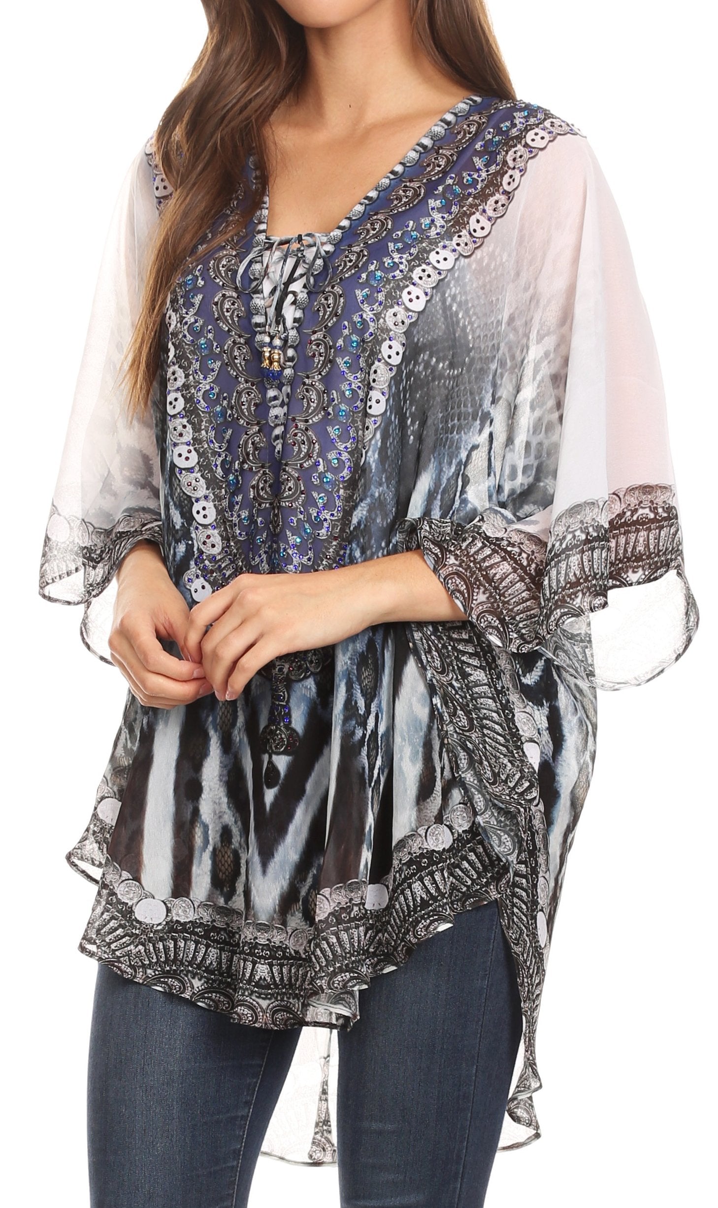 Woman wearing a patterned blouse with sheer sleeves on a white background
