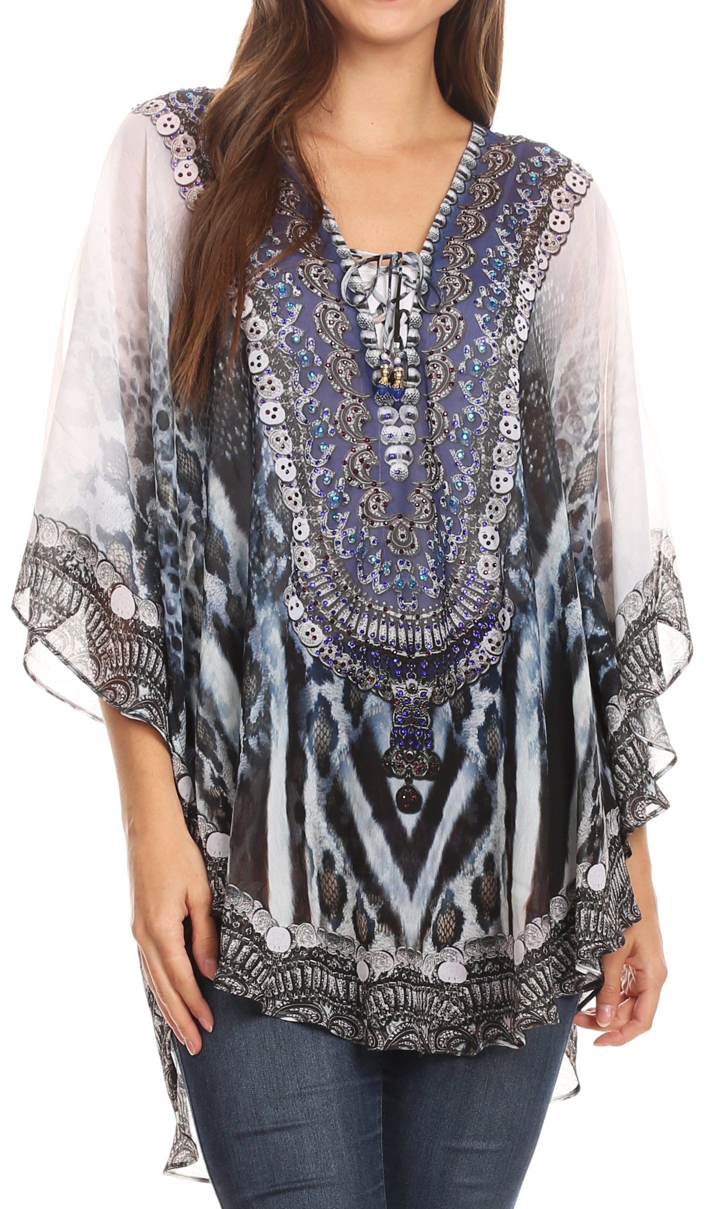 Woman wearing a patterned blouse with sheer sleeves on a white background