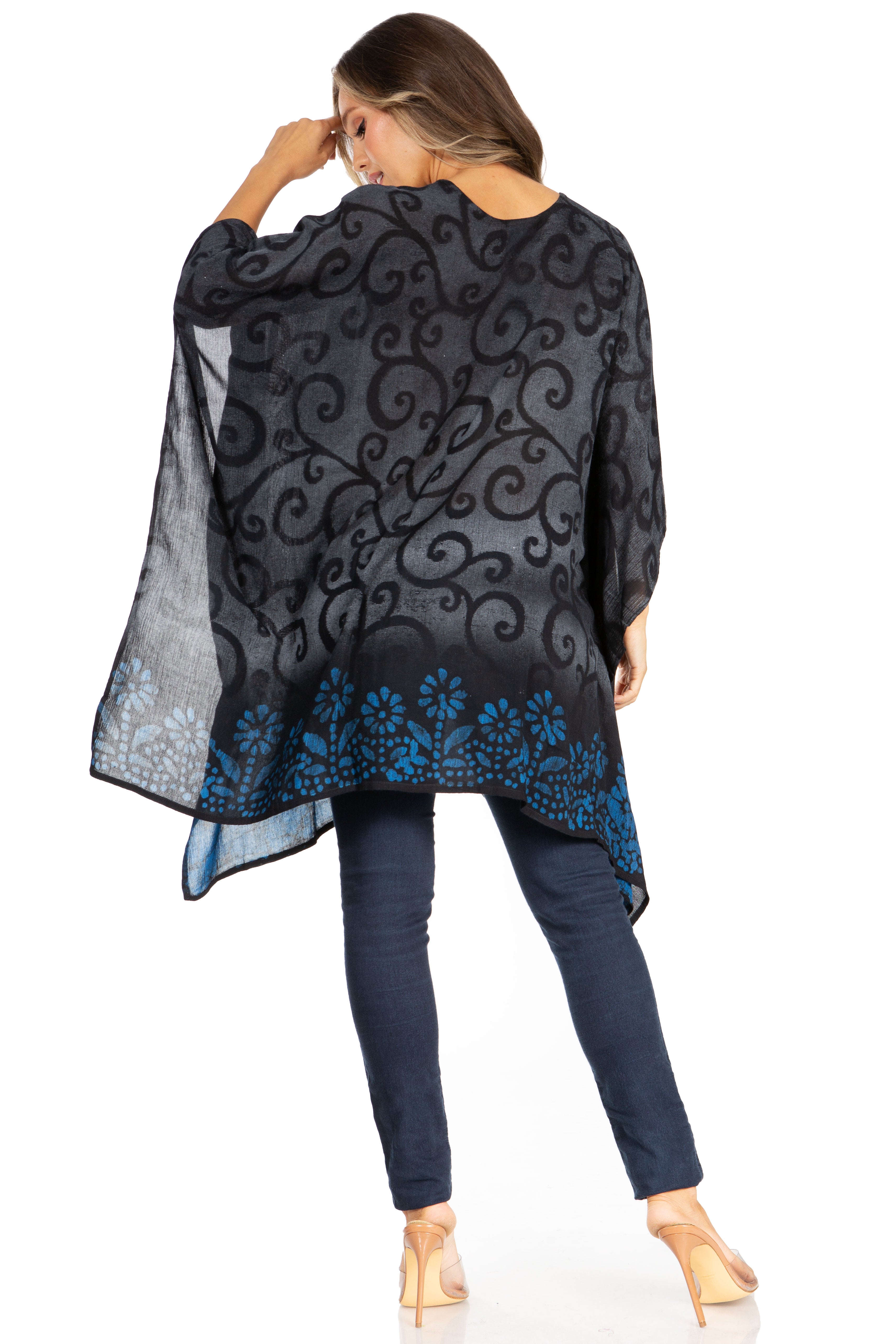 Woman wearing a black and blue patterned top with a white background