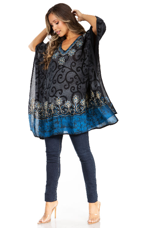 Woman wearing a black and blue patterned dress with leggings on a white background