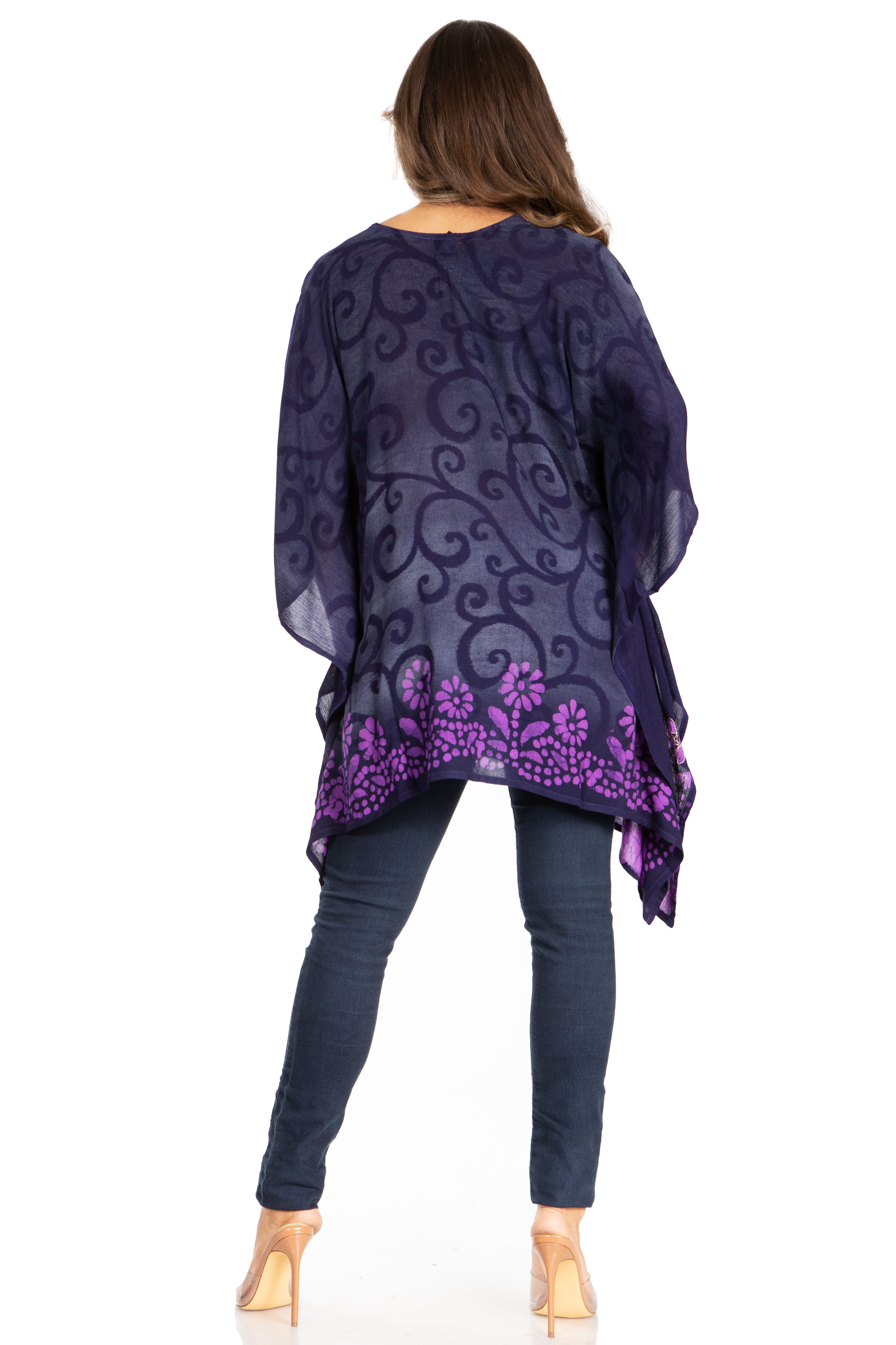 Woman wearing a purple patterned top and jeans on a white background