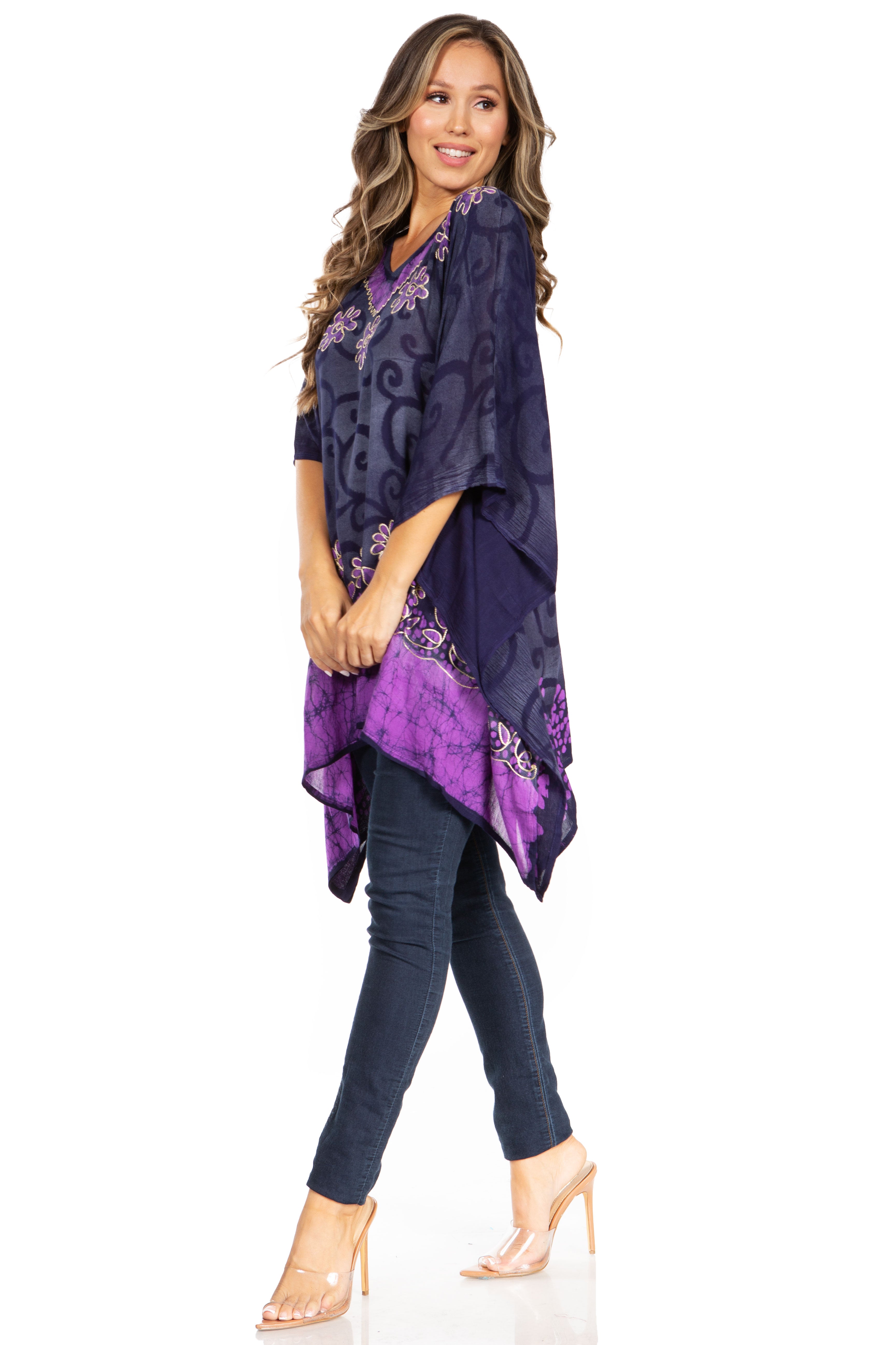 Woman wearing a purple patterned top and jeans on a white background