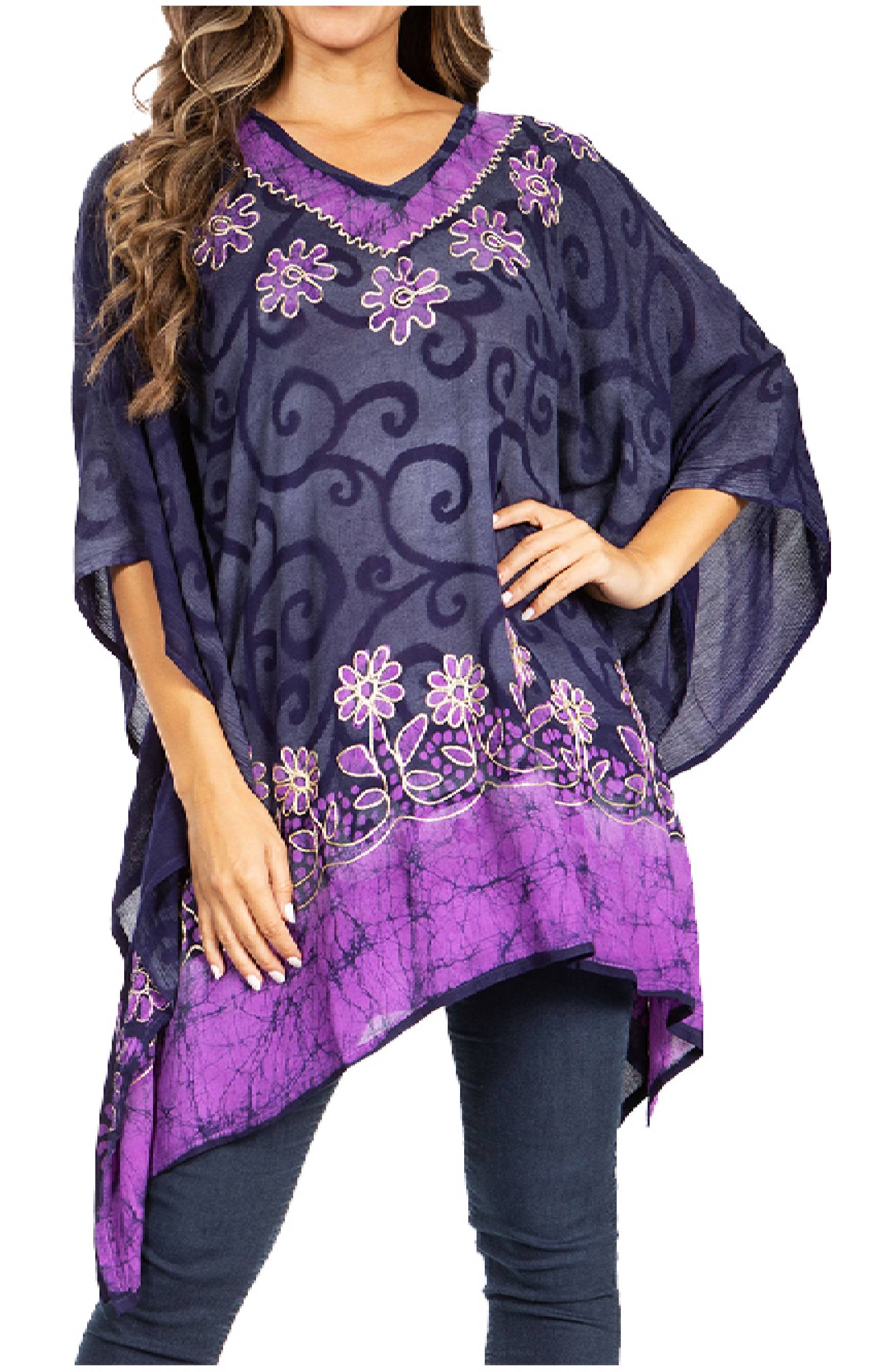 Woman wearing a purple and navy patterned poncho with floral designs.