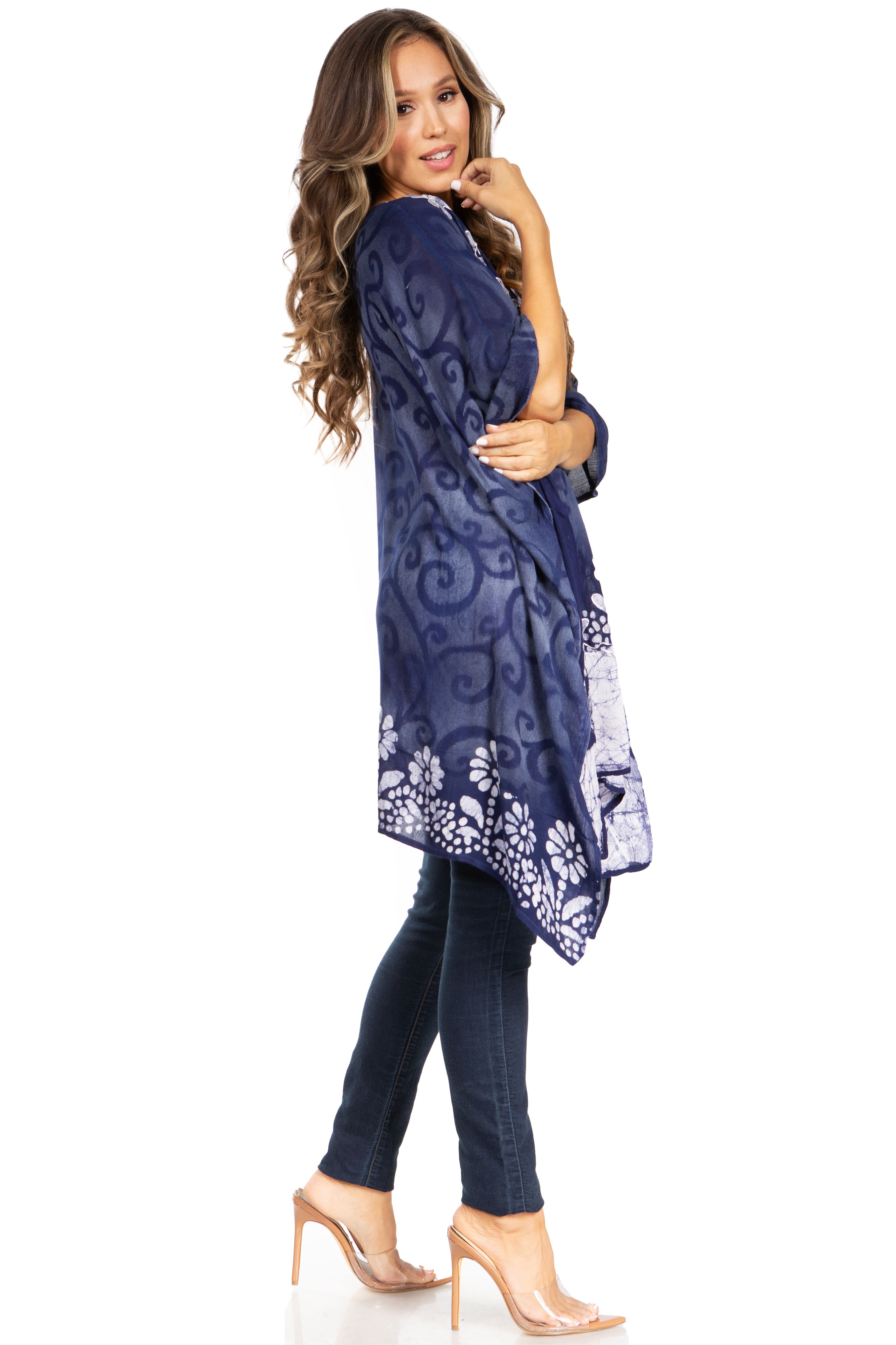 Woman wearing a blue patterned kimono-style garment on a white background