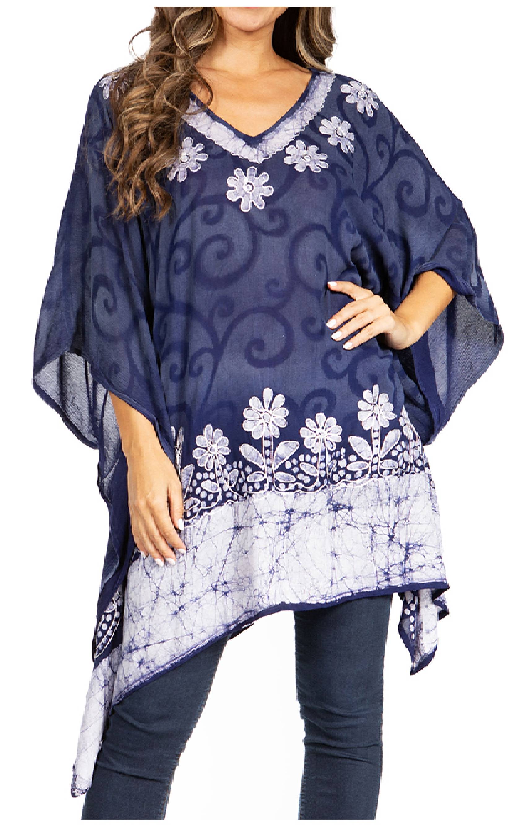 Navy blue poncho with white floral patterns worn by a model on a white background