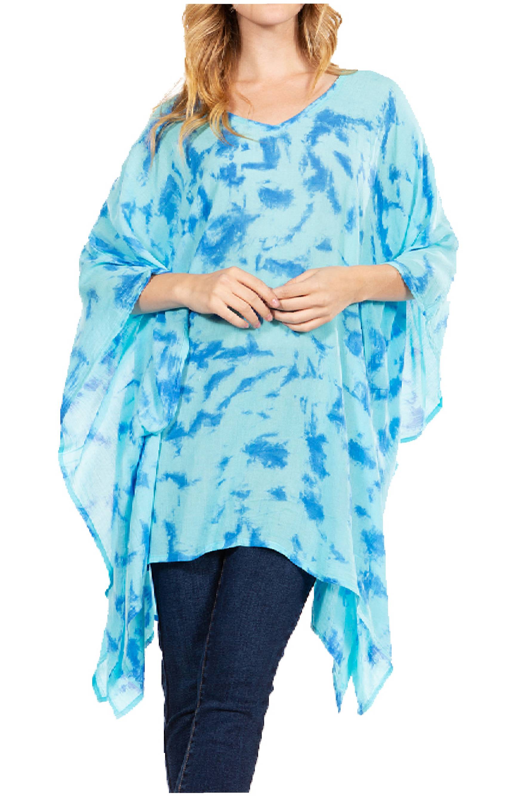 Woman wearing a blue tie-dye poncho over a white background