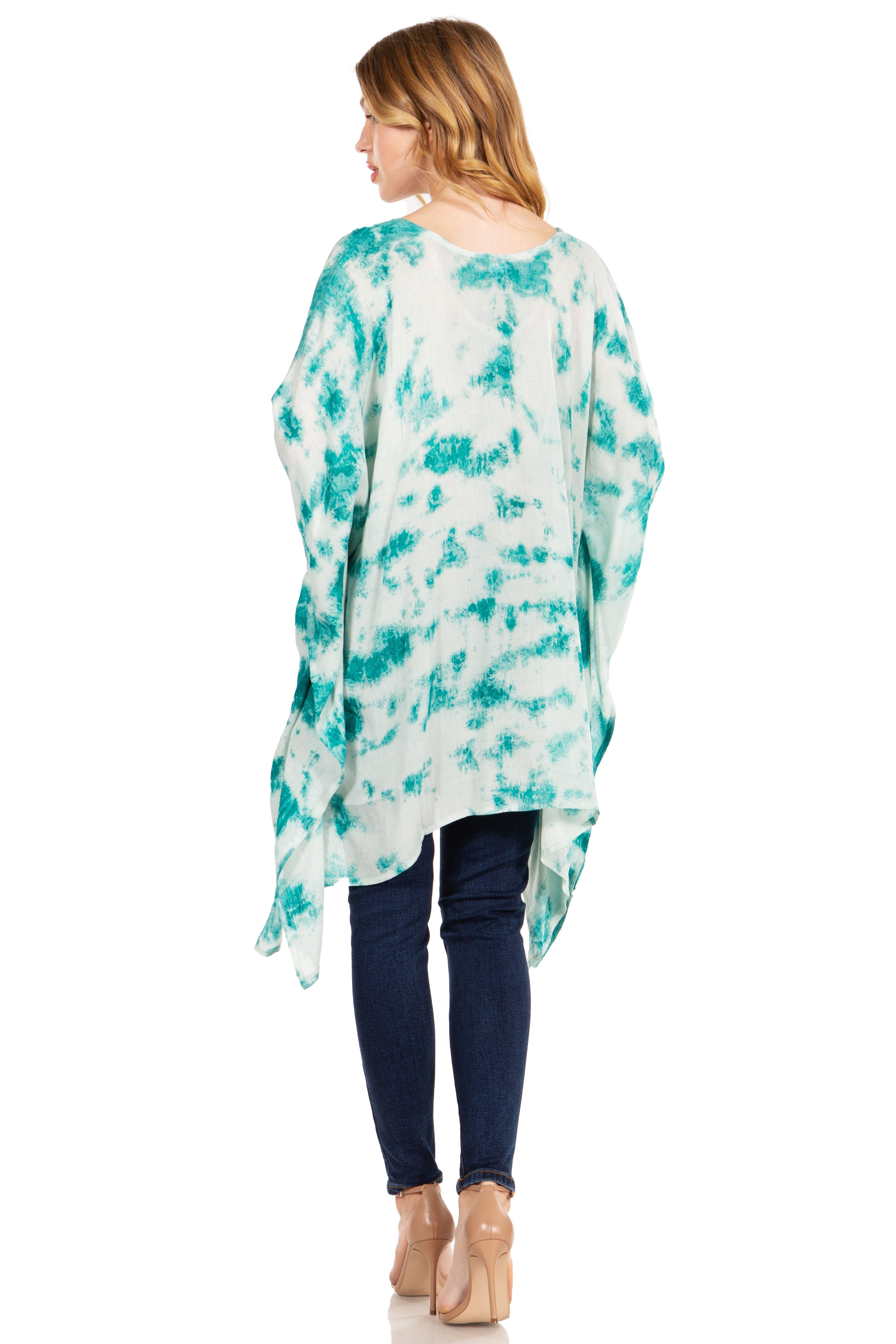 Woman wearing a tie-dye kimono over a white shirt and blue jeans on a white background