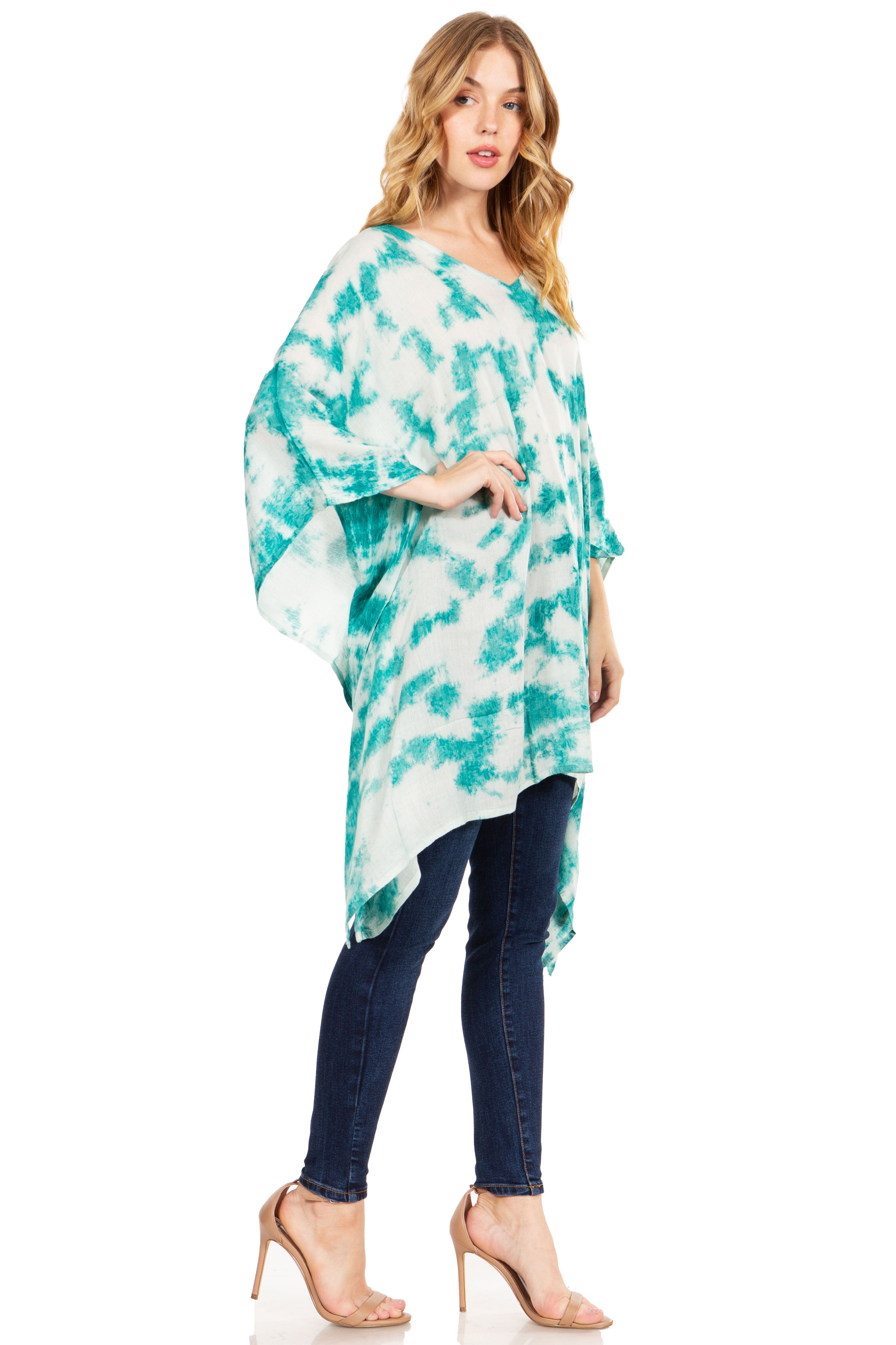 Woman wearing a turquoise and white tie-dye kimono over a blue dress on a white background