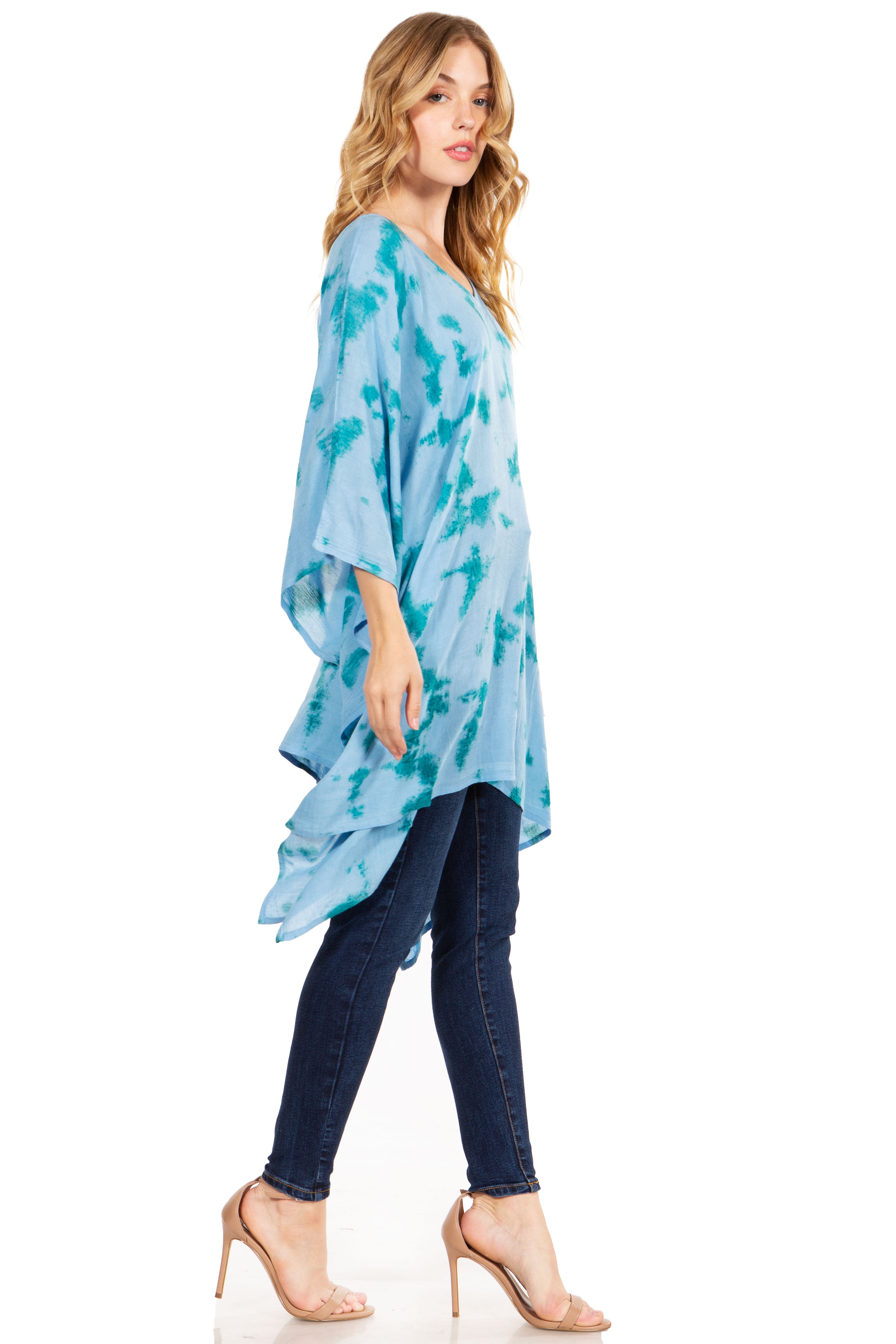 Woman wearing a blue tie-dye top and jeans on a white background
