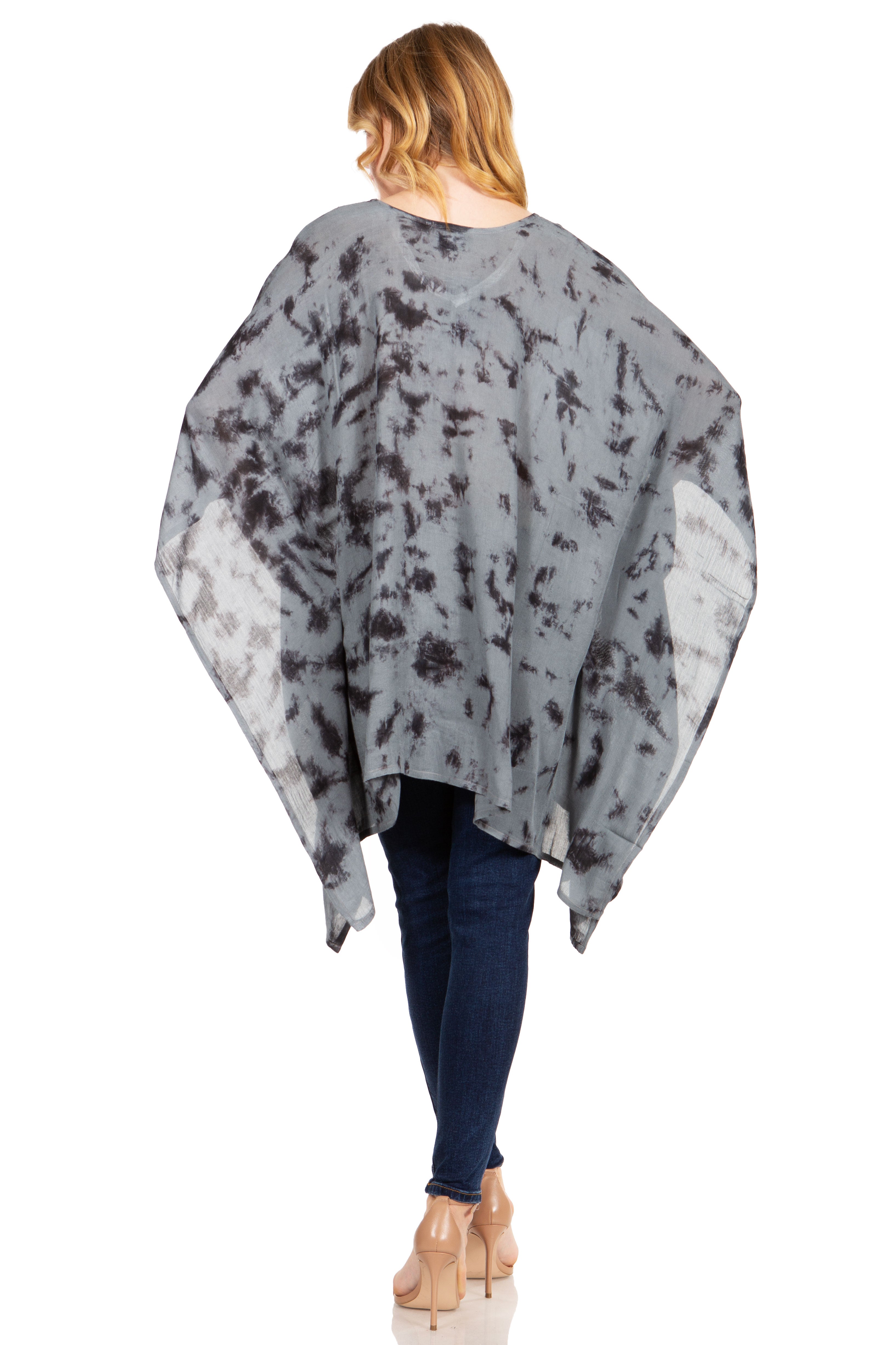 Person wearing a gray floral patterned poncho on a white background