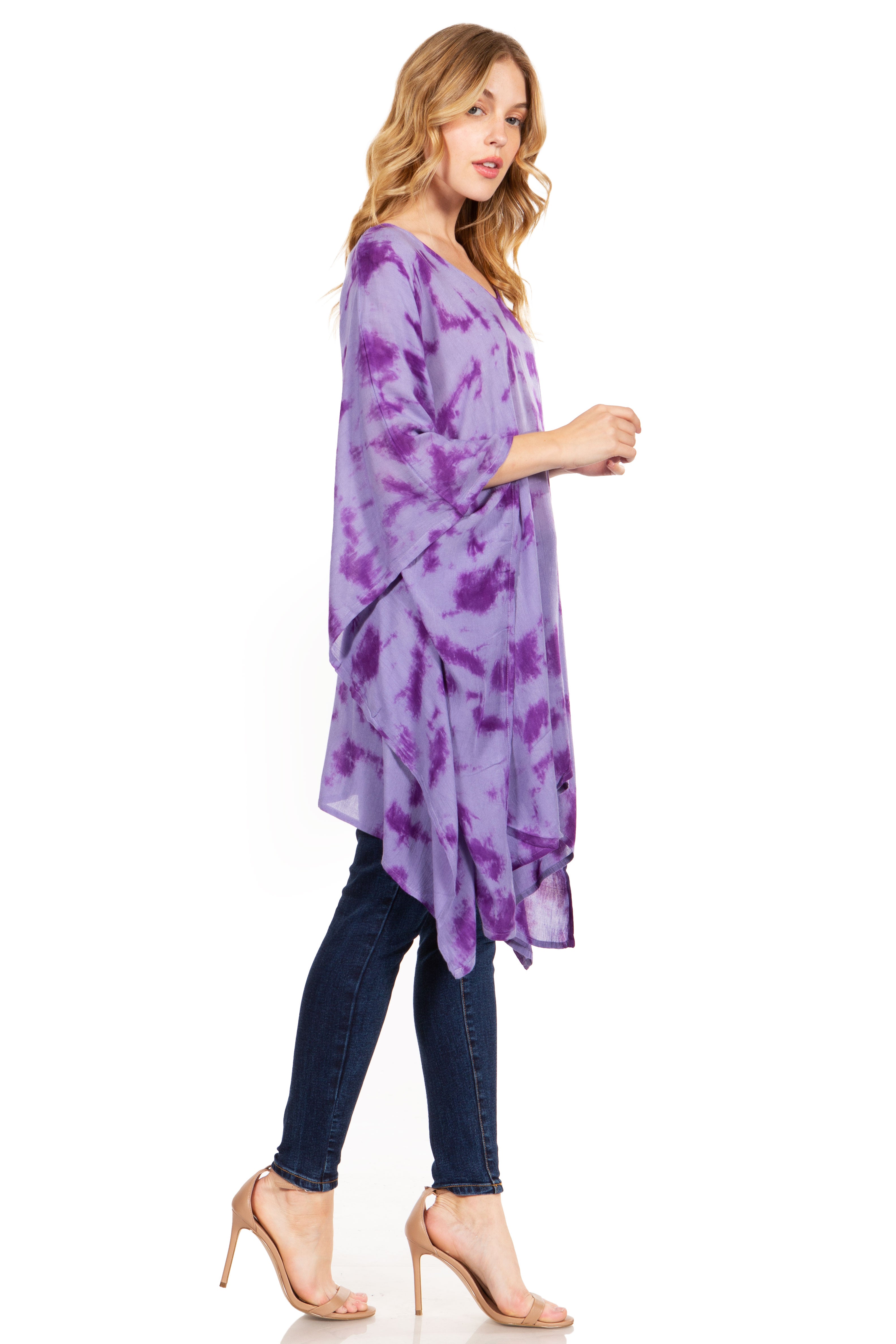 Woman wearing a purple tie-dye shirt and jeans on a white background