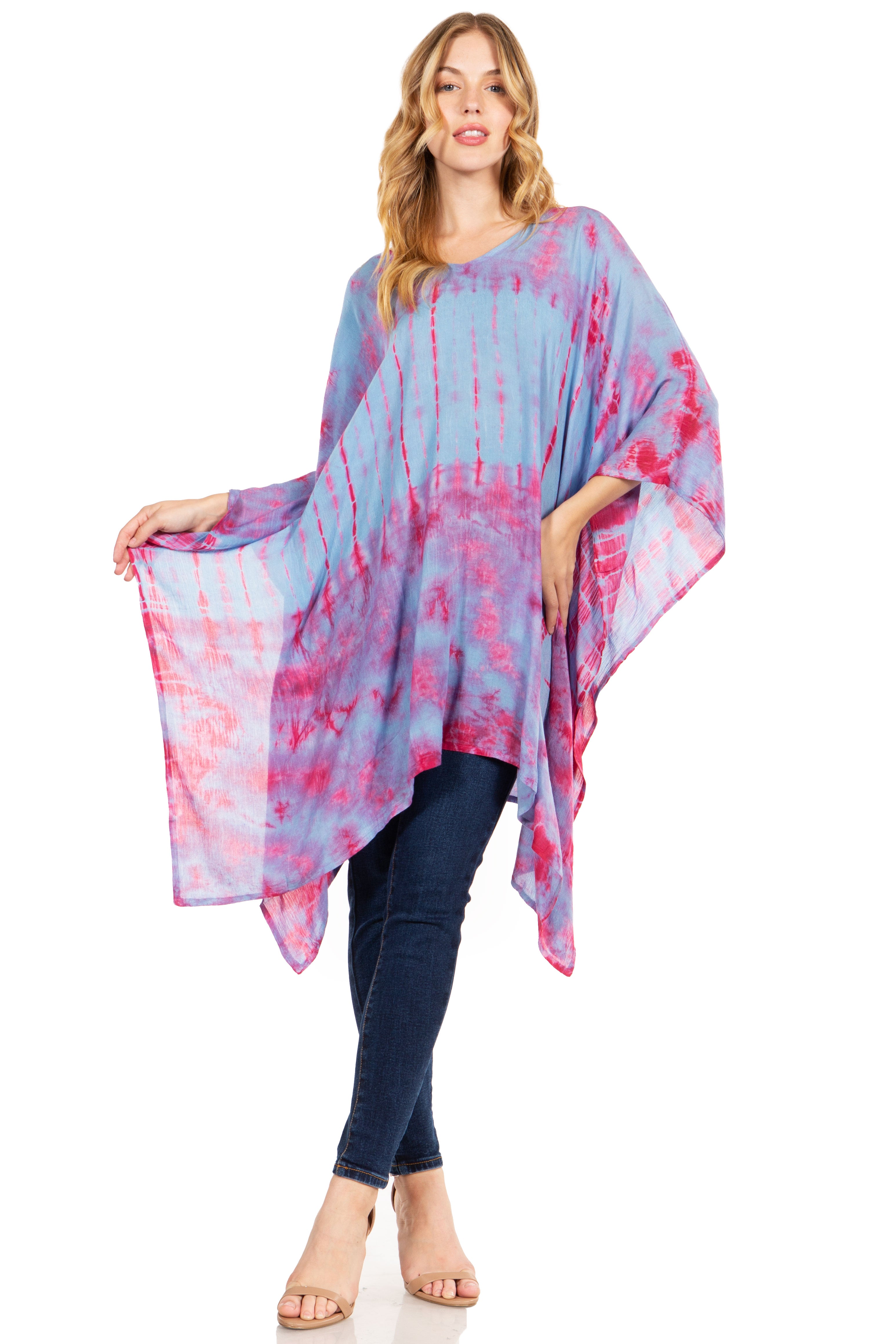 Woman wearing a tie-dye poncho with pink and blue patterns on a white background