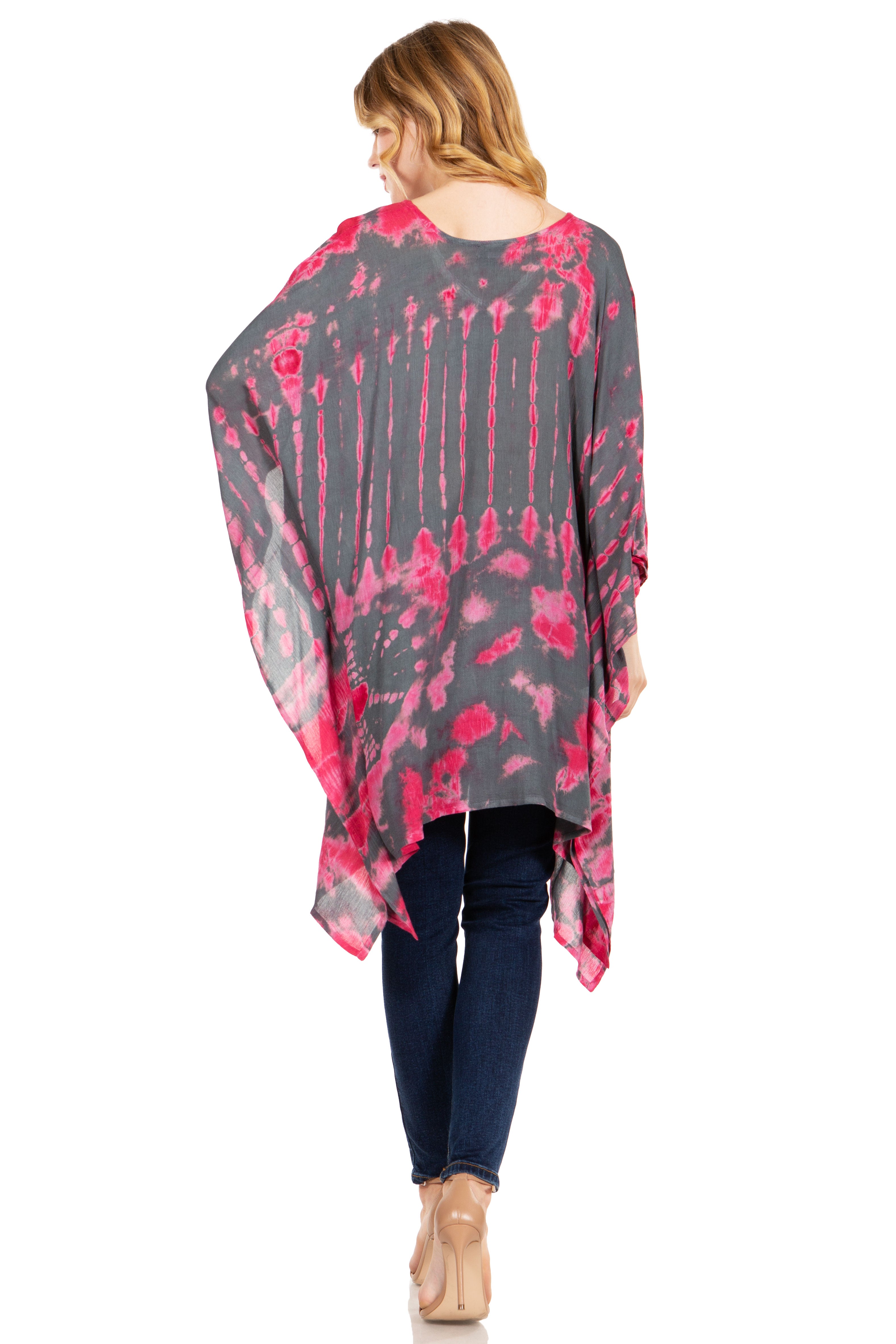 Woman wearing a gray and pink floral kimono over a black top and blue jeans on a white background