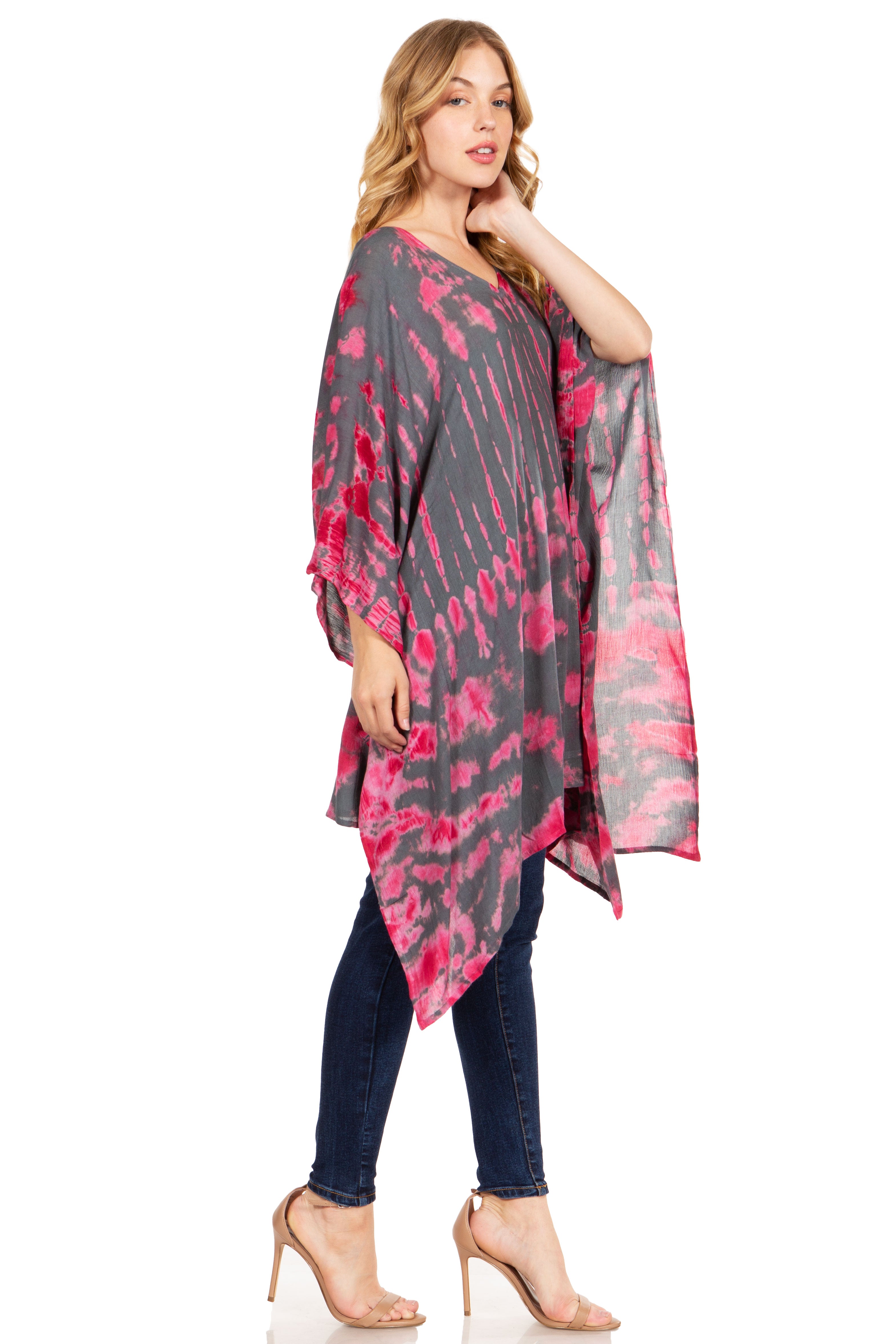 Woman wearing a pink and gray tie-dye kimono over a dark outfit on a white background