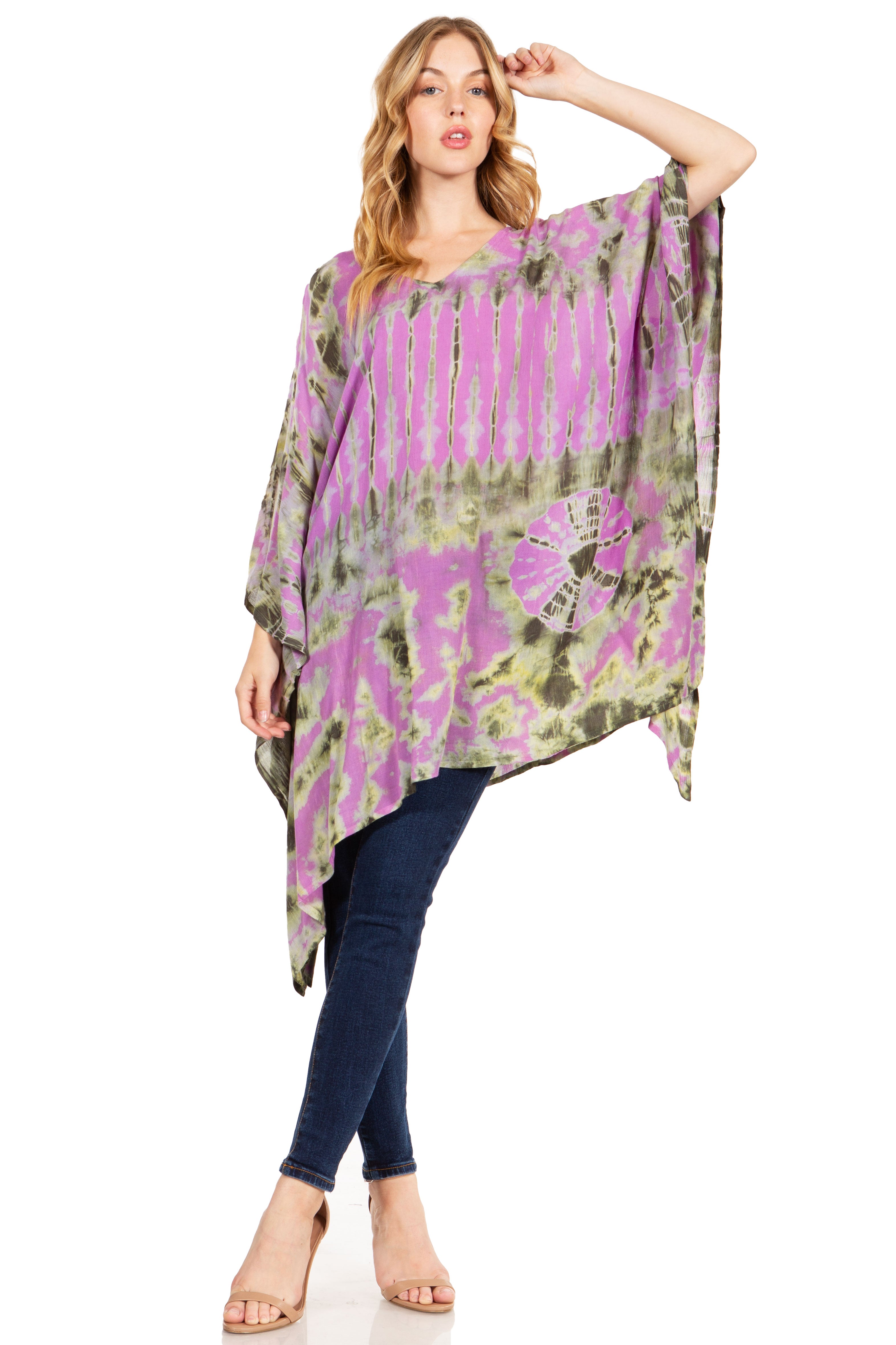 Woman wearing a colorful, patterned poncho over a plain background