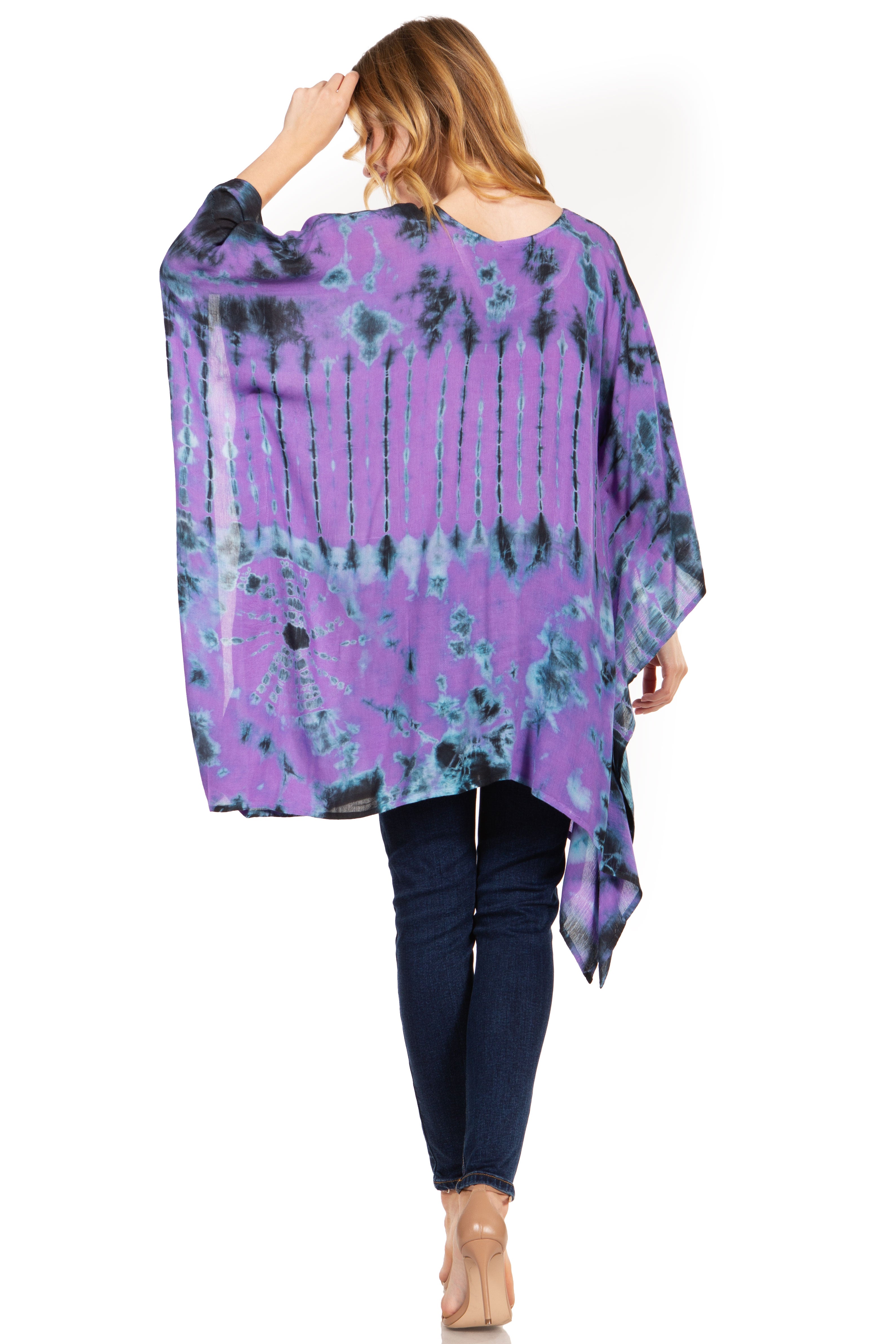 Woman wearing a purple tie-dye poncho with a white background