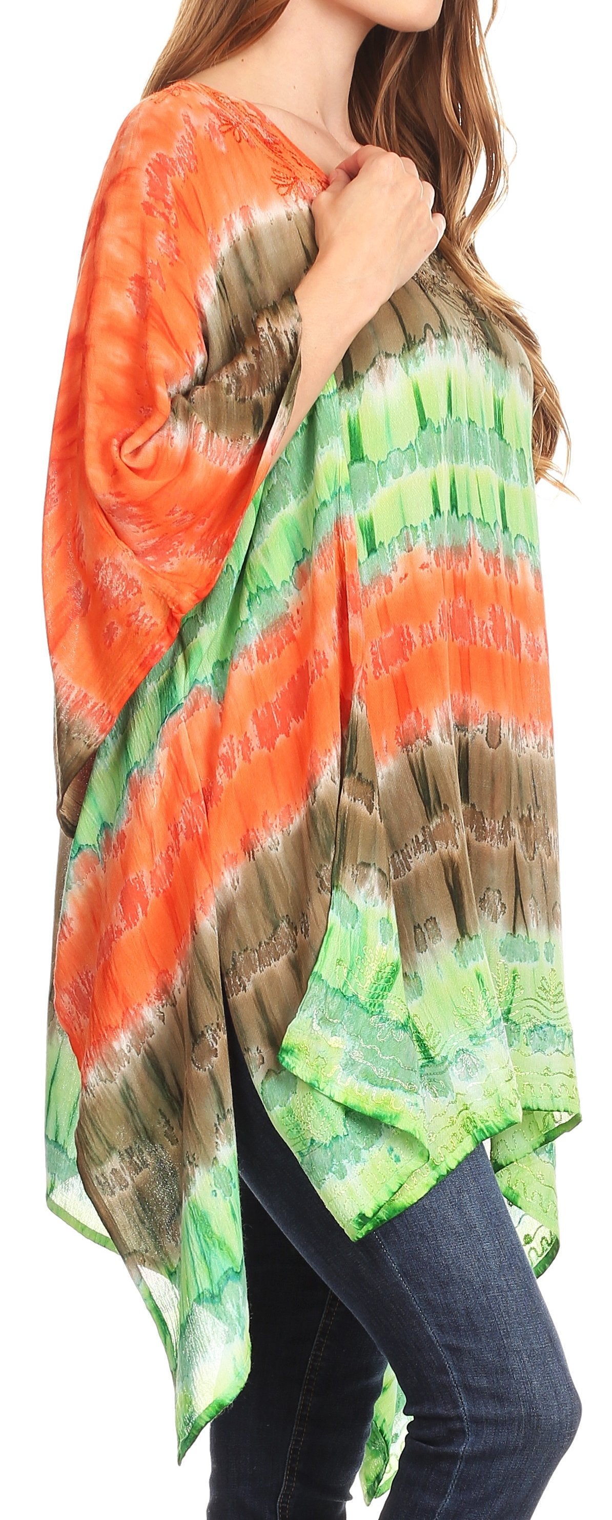 Woman wearing a colorful tie-dye shirt with a pattern of orange, green, and brown.