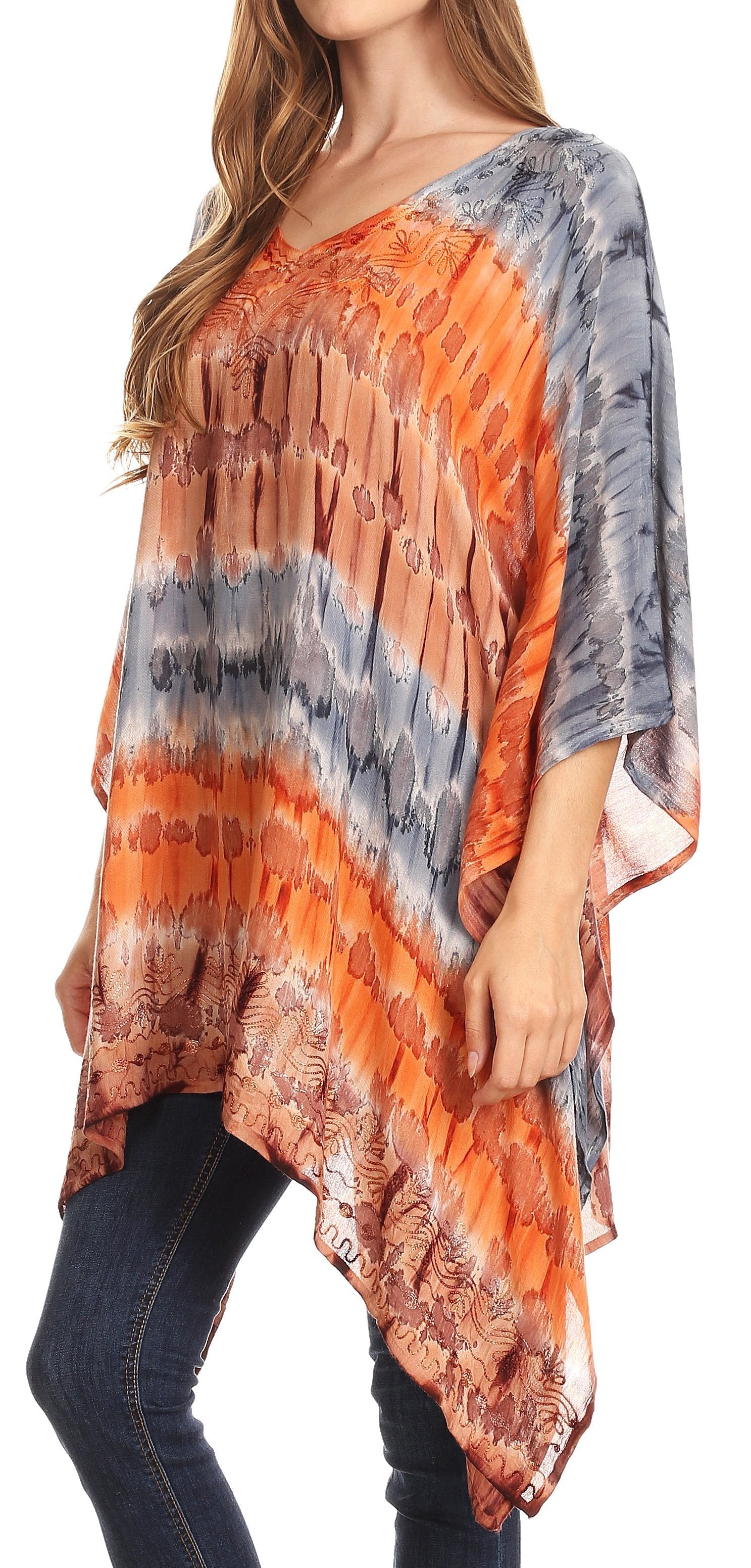 Woman wearing a colorful tie-dye shirt with orange, gray, and blue patterns.