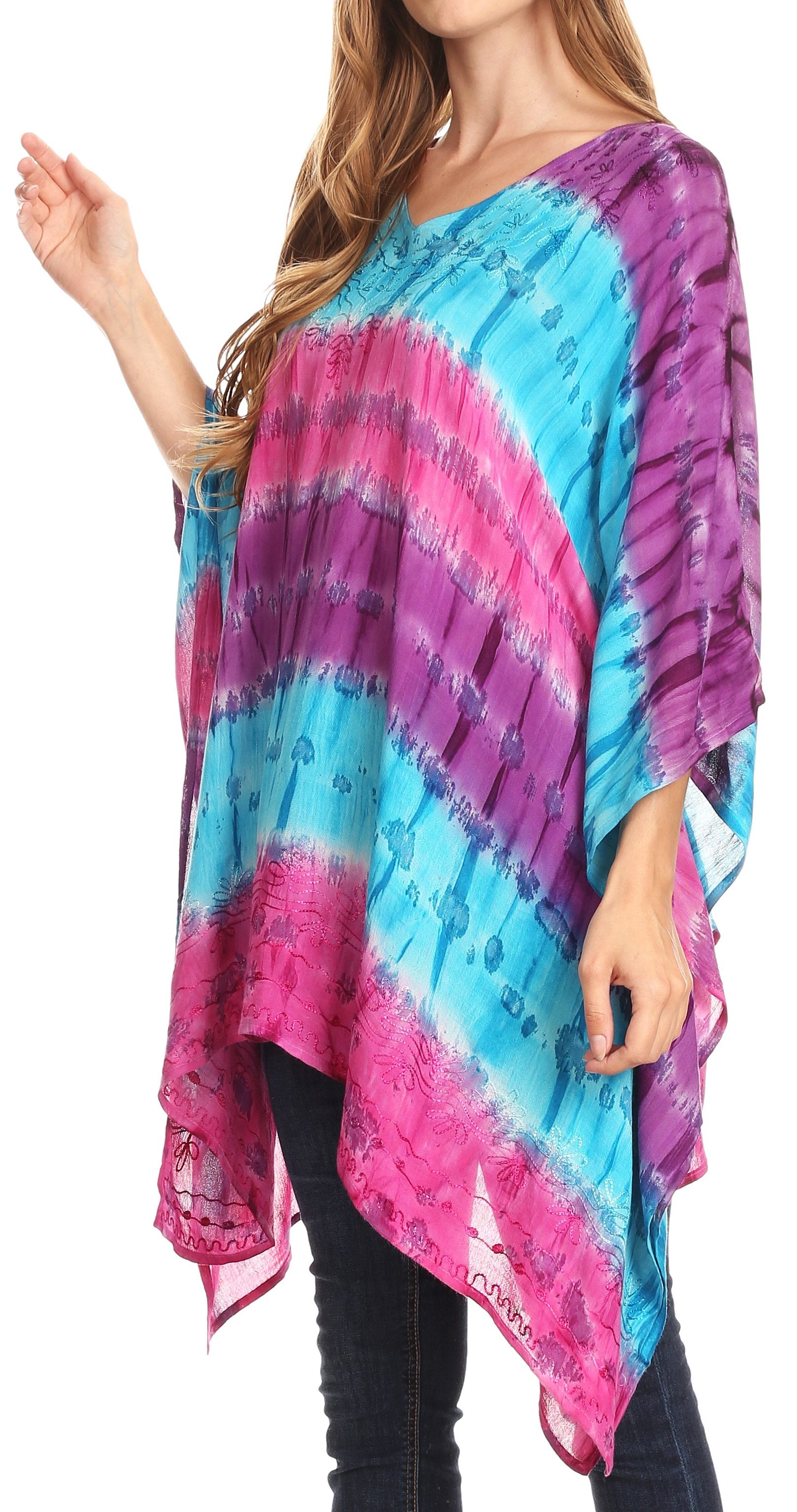 Woman wearing a colorful tie-dye poncho with pink and blue patterns on a white background