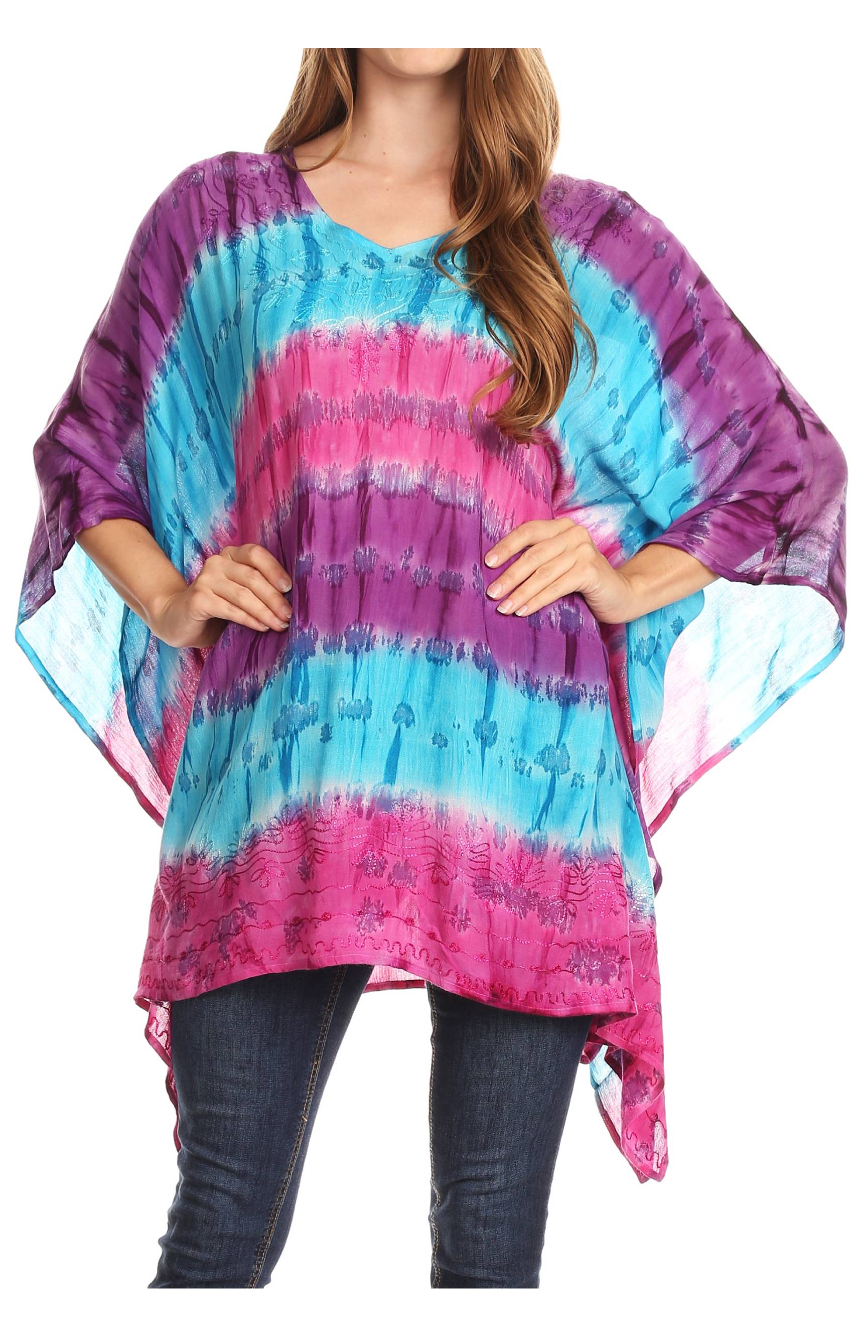 Woman wearing a tie-dye poncho with pink and blue patterns on a white background