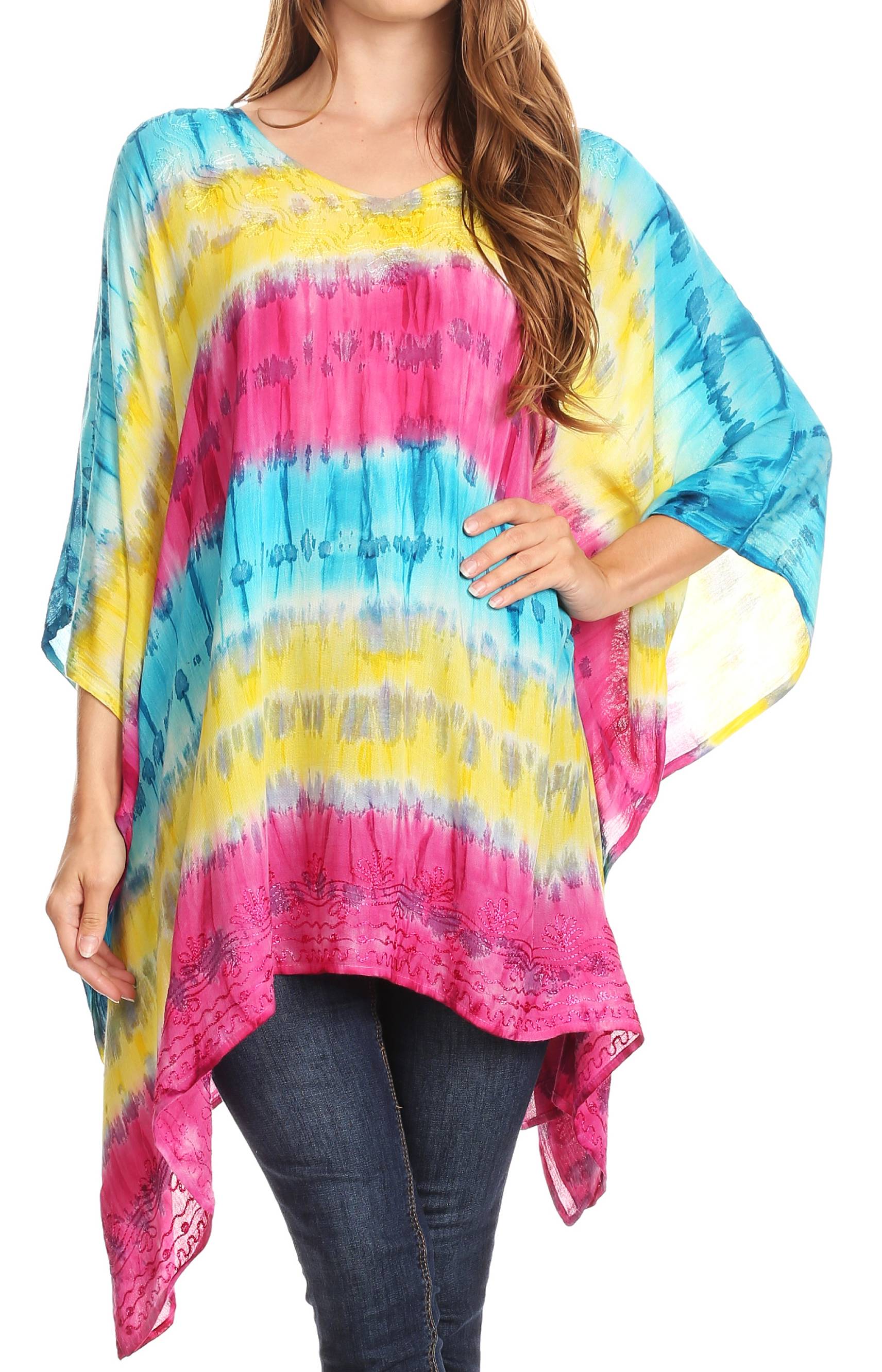 Woman wearing a colorful tie-dye poncho with pink, yellow, and blue hues on a white background.