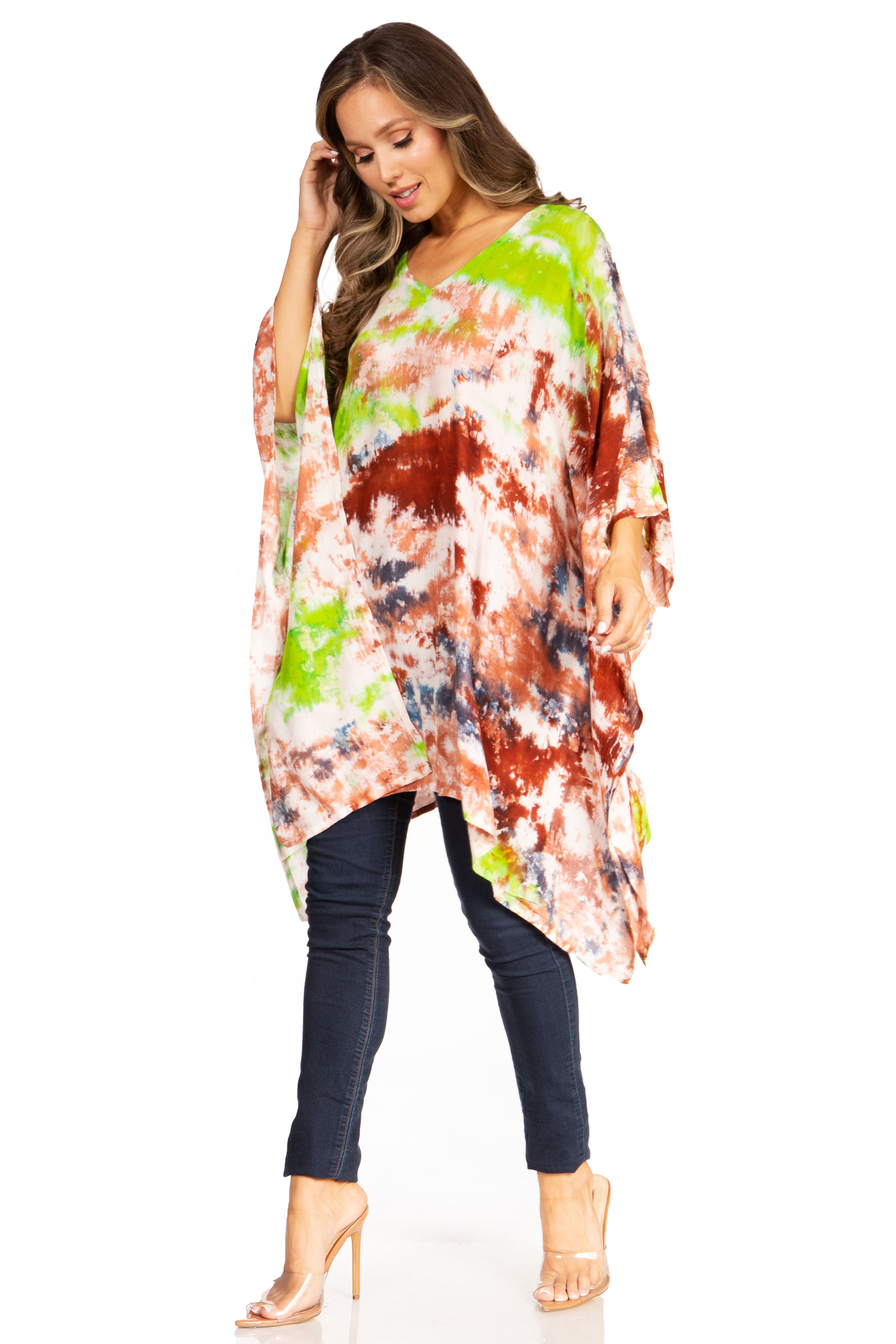 Woman wearing a colorful tie-dye poncho with a white background