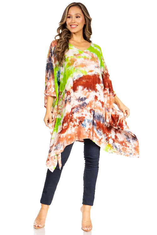 Woman wearing a colorful tie-dye top and dark pants on a white background
