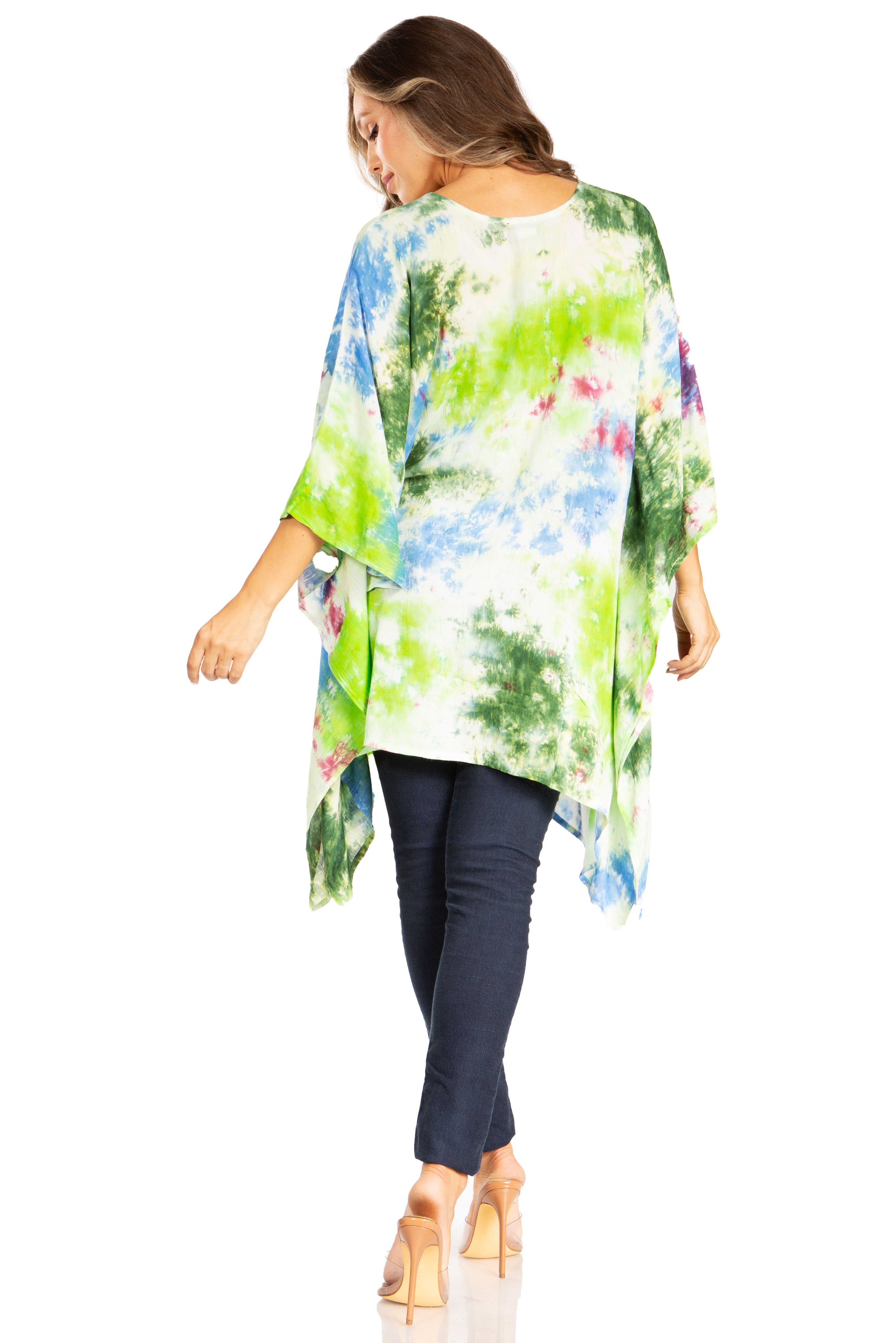 Woman wearing a colorful tie-dye kimono over a dark outfit on a white background