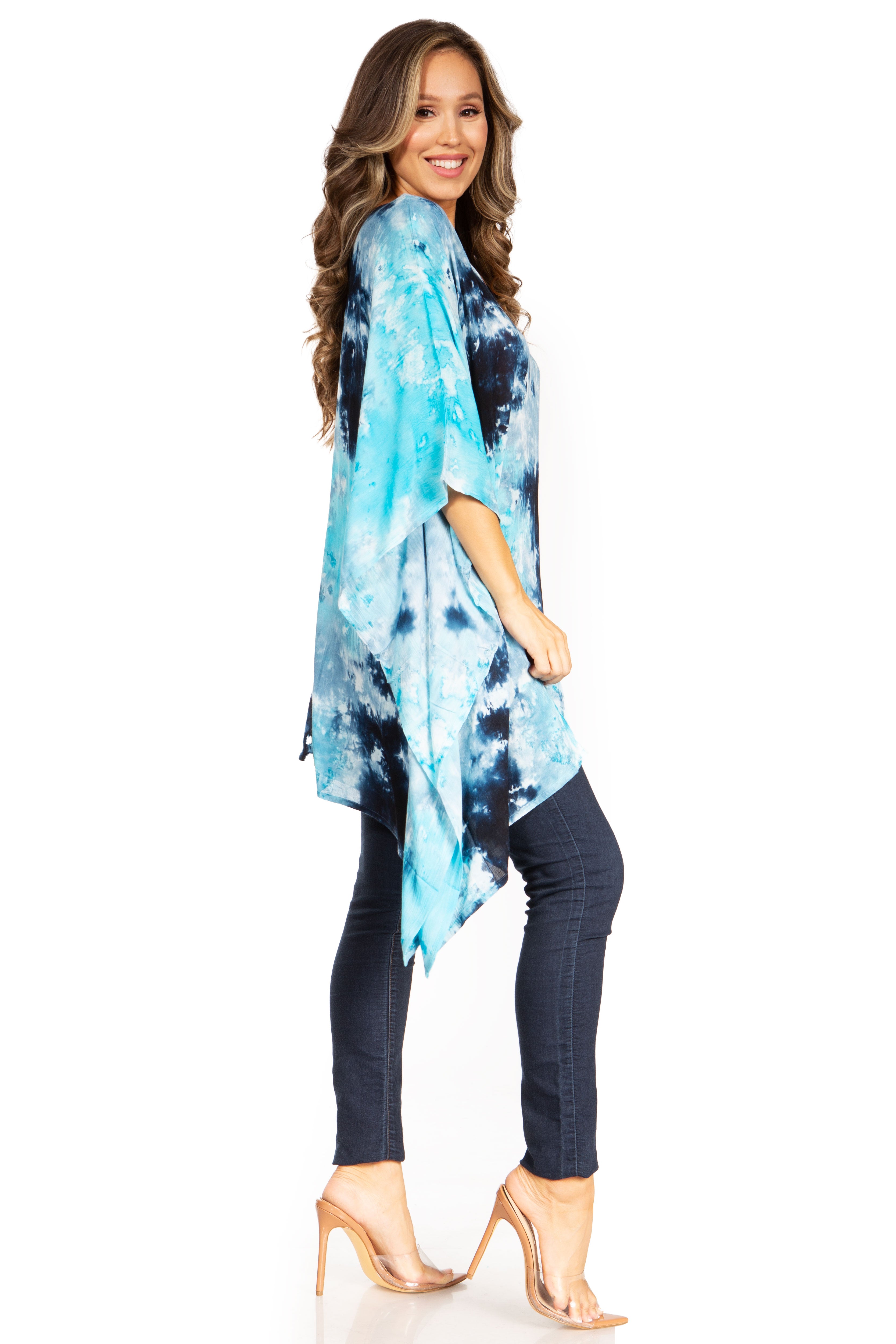 Woman wearing a blue tie-dye kimono over a black outfit on a white background