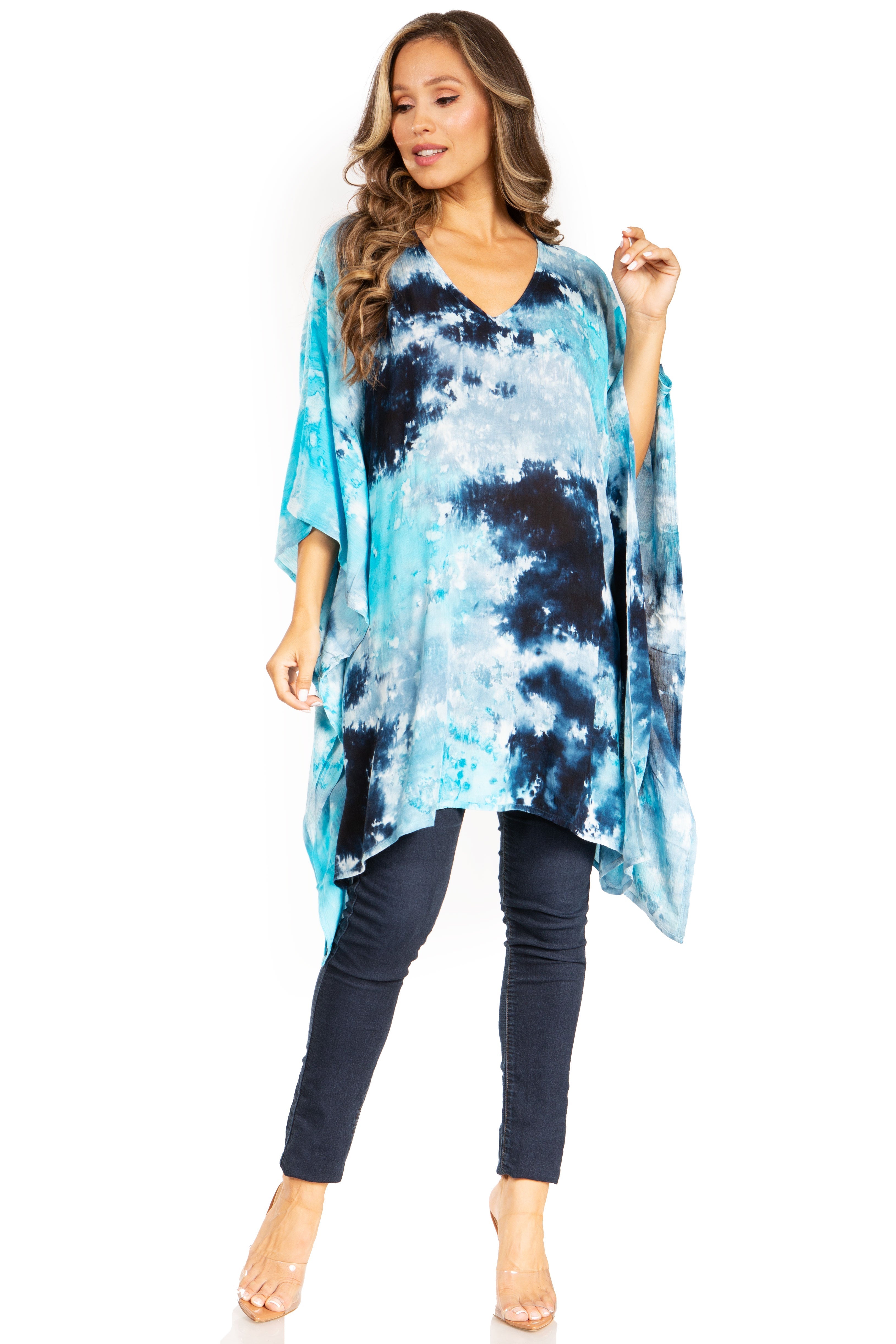 Woman wearing a blue tie-dye kimono over a black outfit on a white background