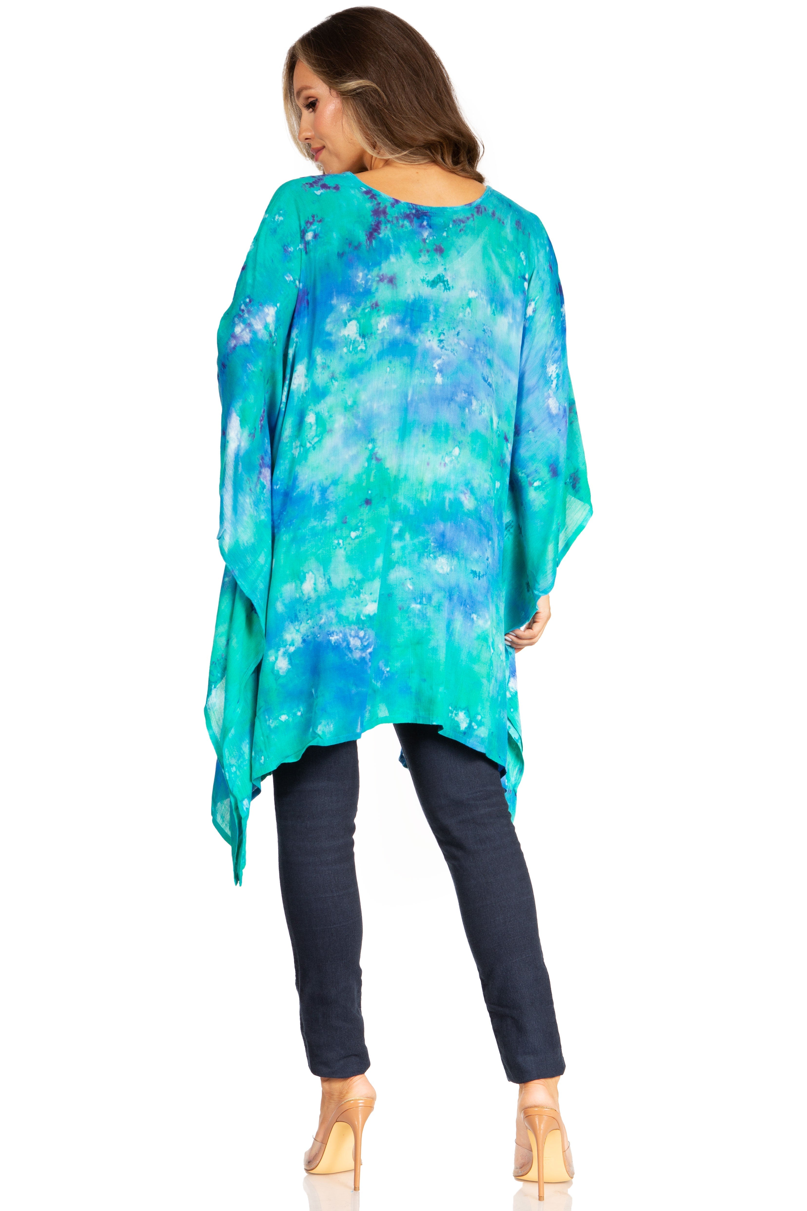 Woman wearing a colorful, long-sleeve top with a white background