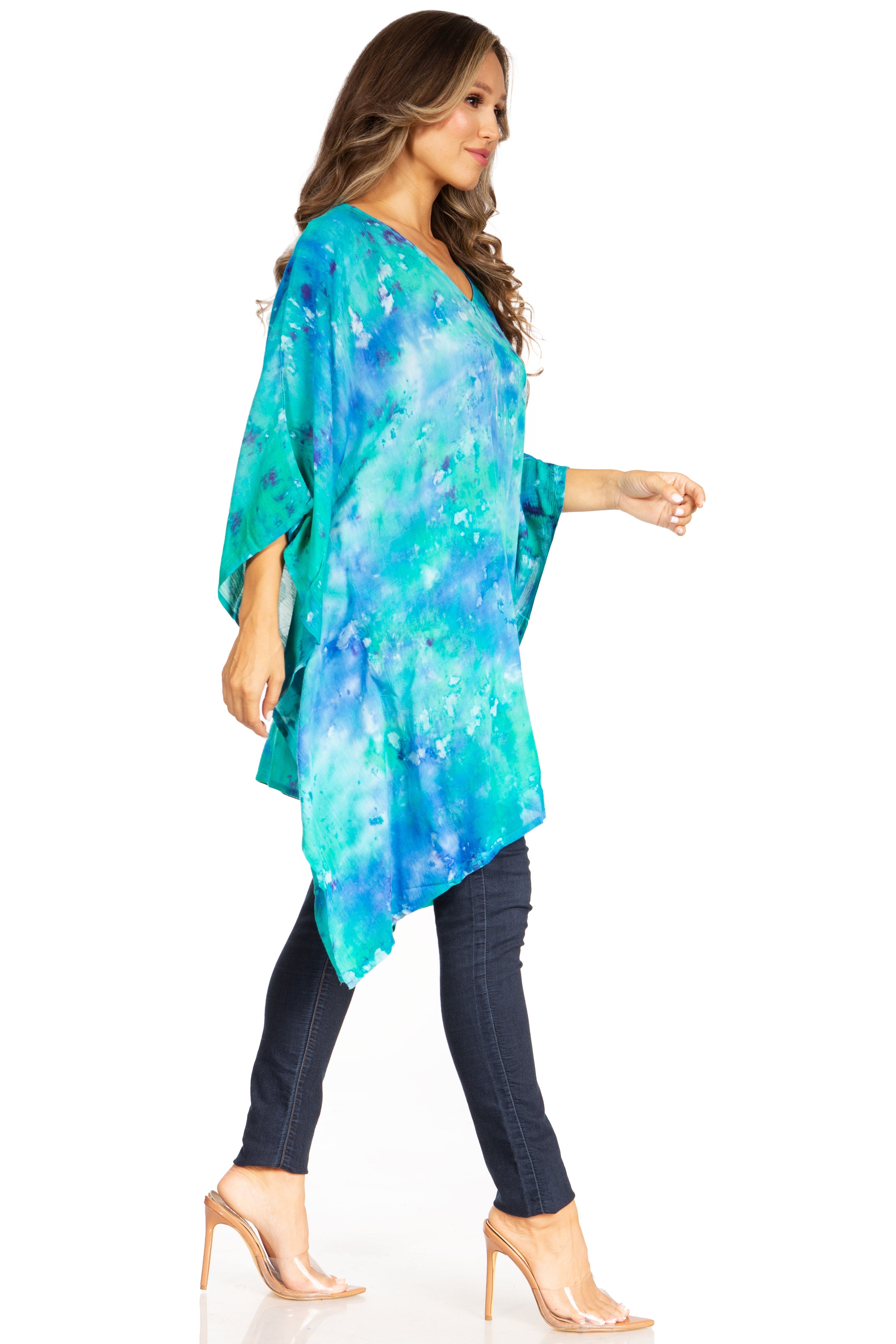 Woman wearing a blue and green patterned kimono-style garment on a white background