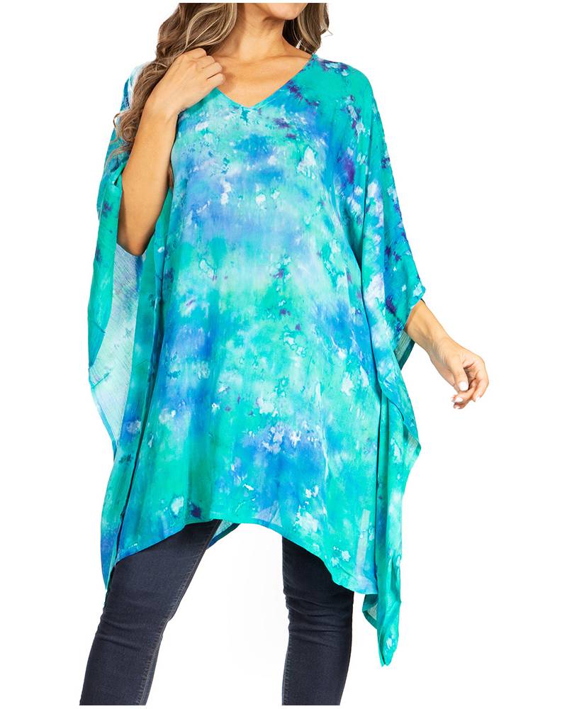 Woman wearing a blue and green tie-dye poncho on a white background