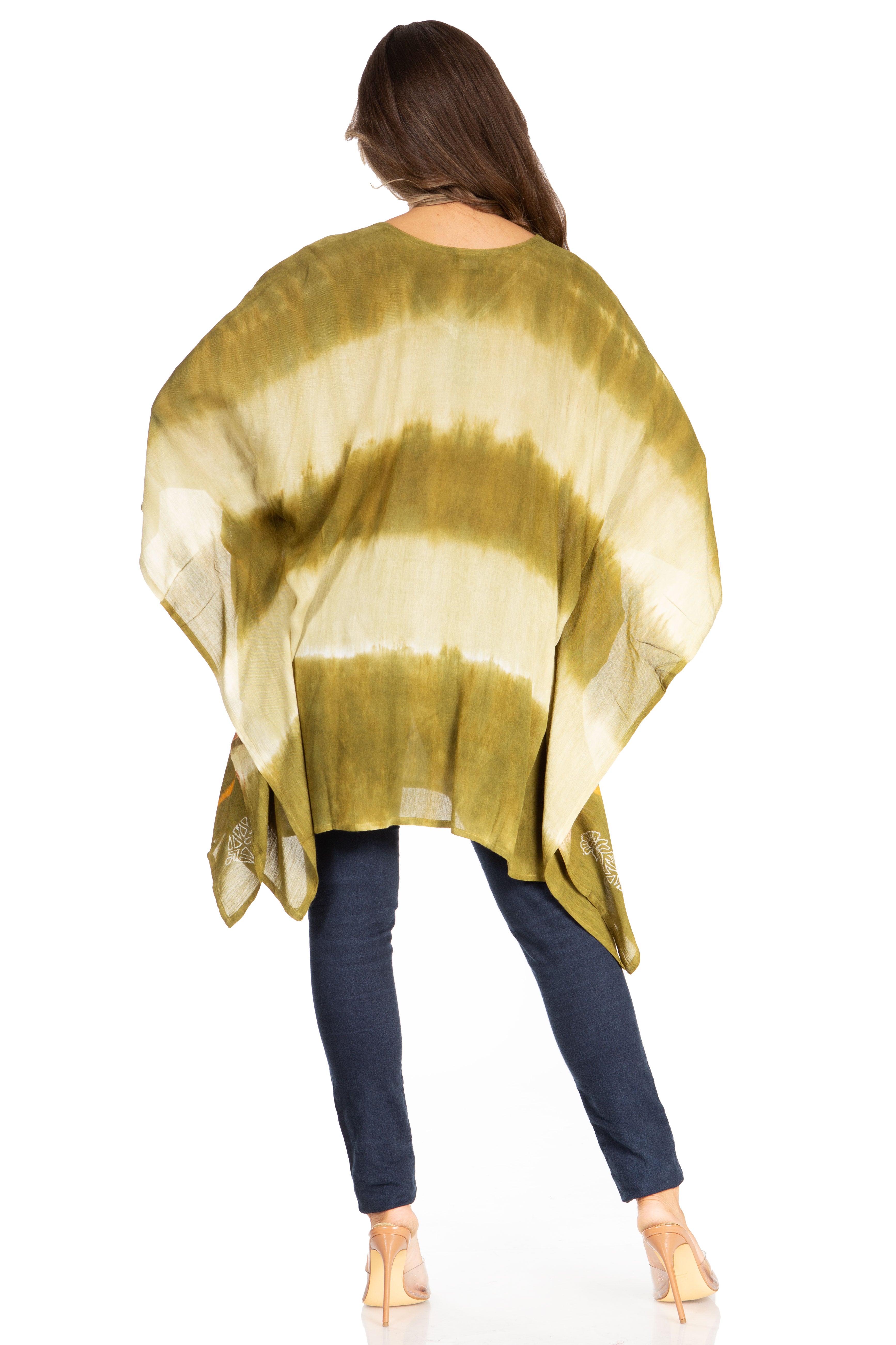 Woman wearing a gold and beige tie-dye shawl over a blue outfit on a white background