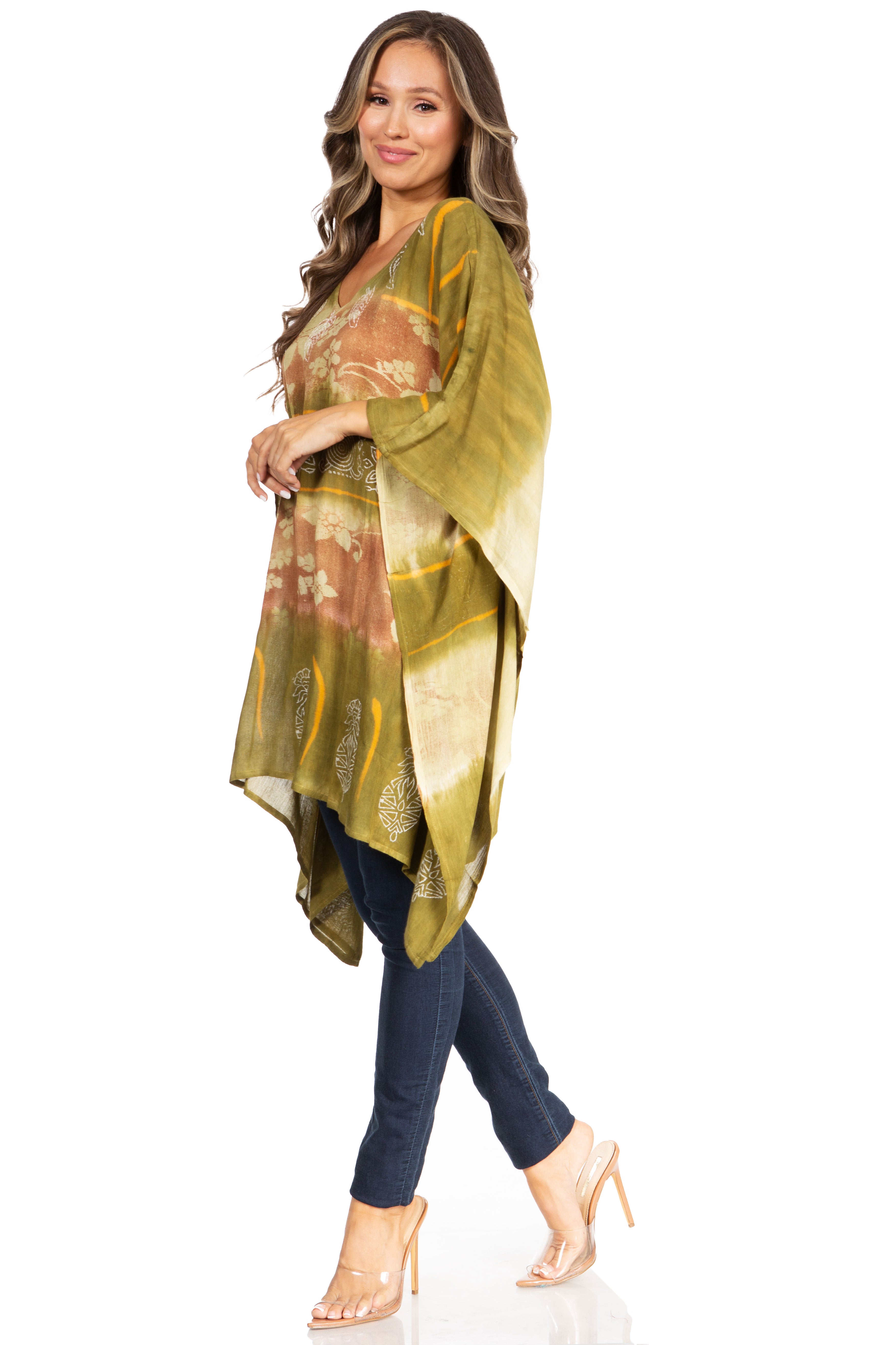 Woman wearing a green and gold patterned kimono over a dark outfit on a white background