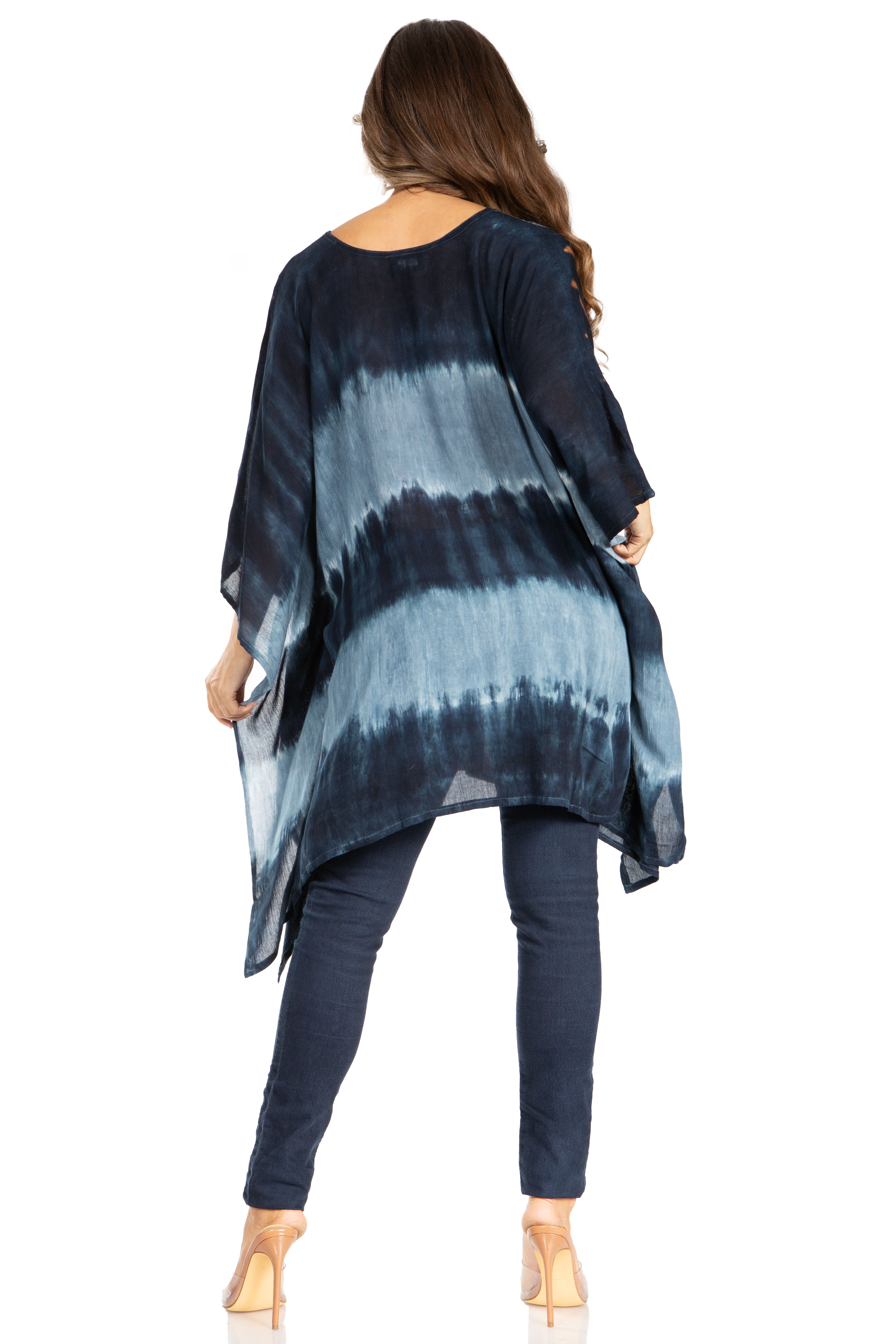 Woman wearing a blue and black tie-dye kimono over a plain background